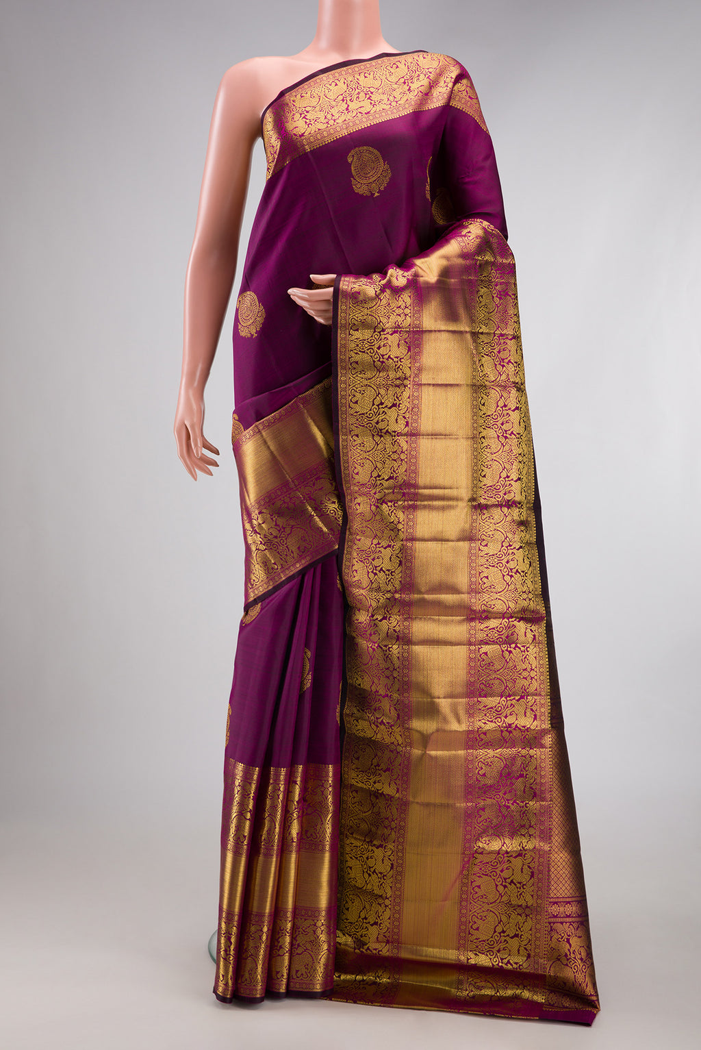 Magenta Dual Tone Kanchipuram Silk Saree with Zari Butta on the body and Fancy Border.  displayed on a mannequin