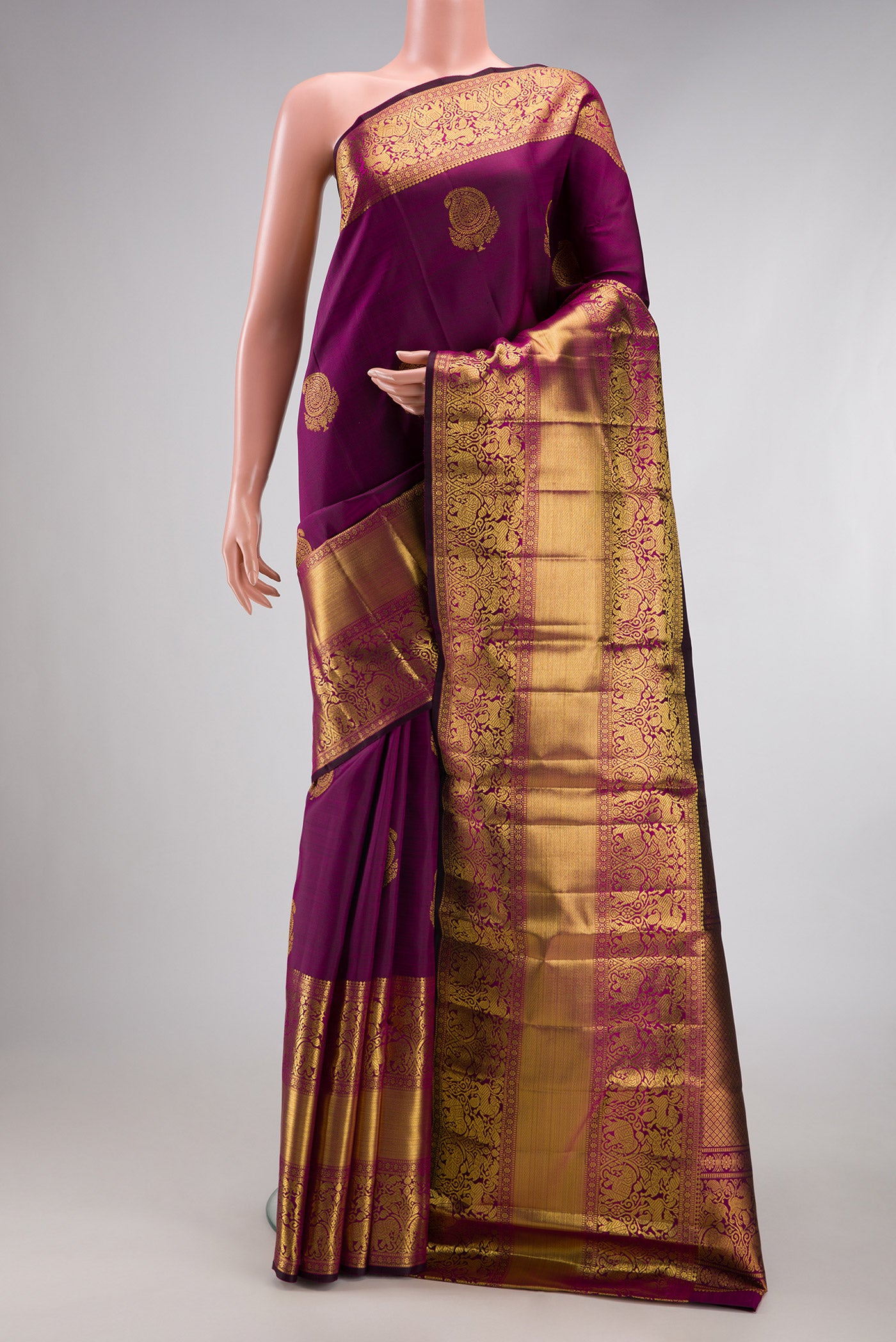 Magenta Dual Tone Kanchipuram Silk Saree with Zari Butta on the body and Fancy Border.  displayed on a mannequin