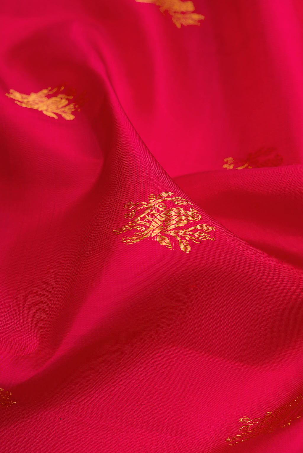 Close up of Maroon Kanchipuram Silk Saree with Zari Butta on the body and Paithani Border.  displaying folds