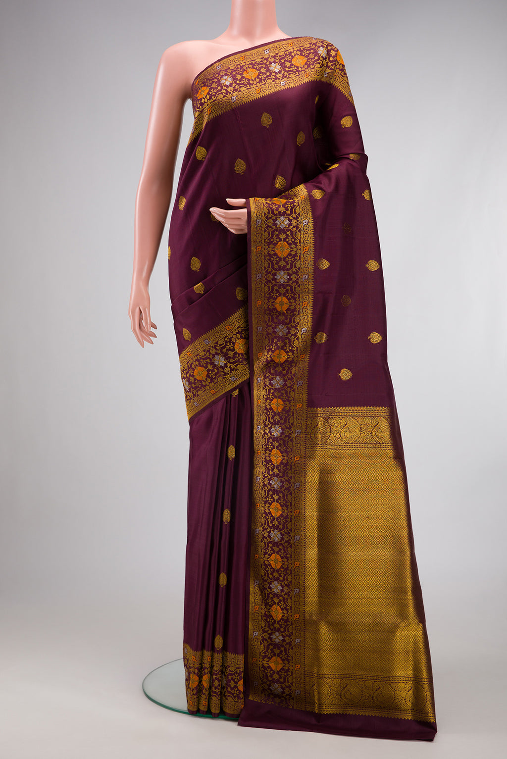 Coffee Brown Kanchipuram Silk Saree with Zari Butta on the body and Fancy Border.  displayed on a mannequin