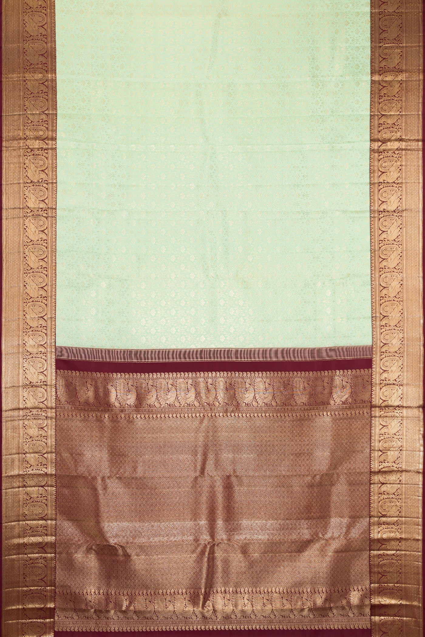 Flat view of Pista Green Kanchipuram Silk Saree with Zari Brocade on the body and Zari Border. 