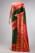 Bottle Green Kanchipuram Silk Saree with Veldhari on the body and Zari Border.  displayed on a mannequin
