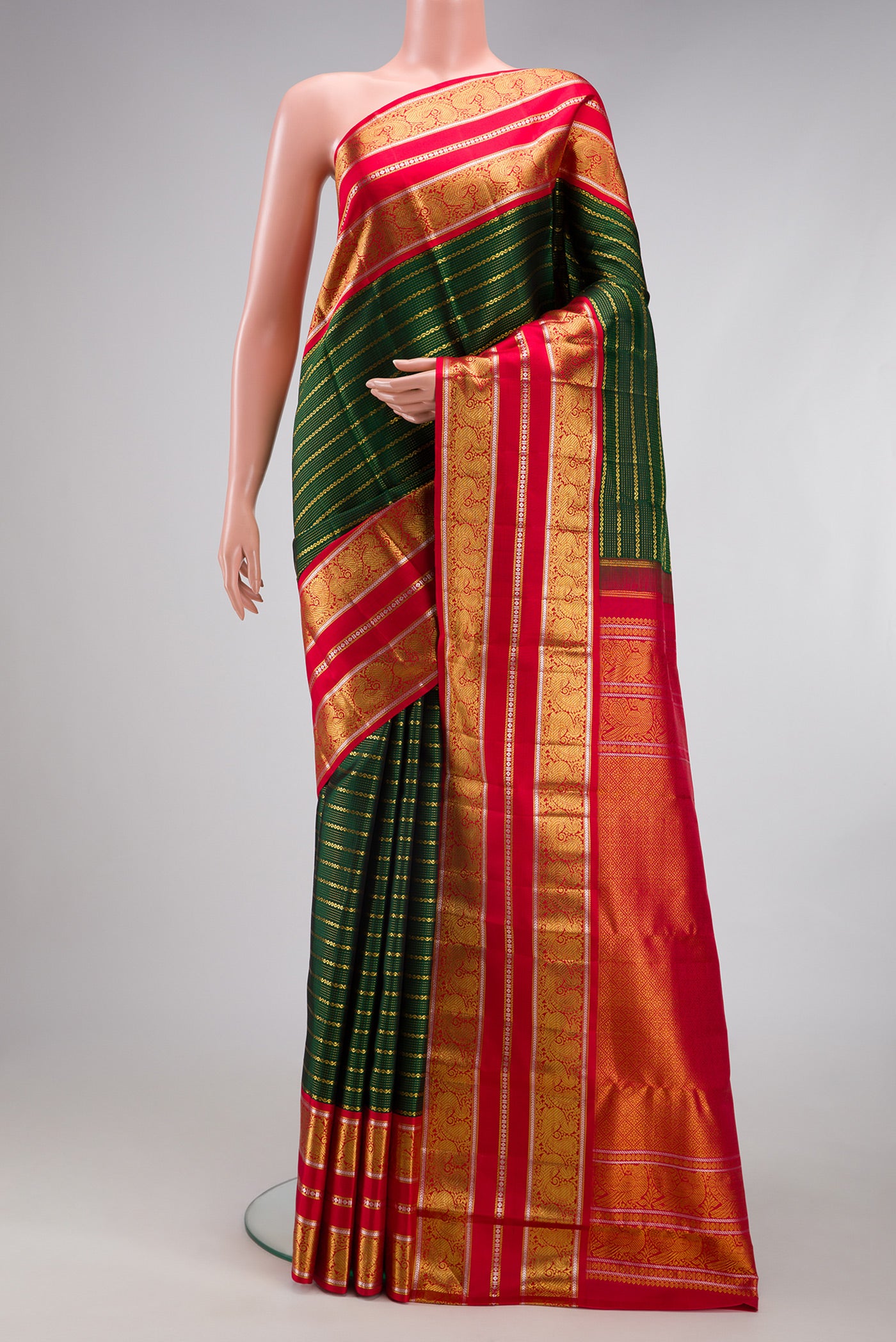 Bottle Green Kanchipuram Silk Saree with Veldhari on the body and Zari Border.  displayed on a mannequin