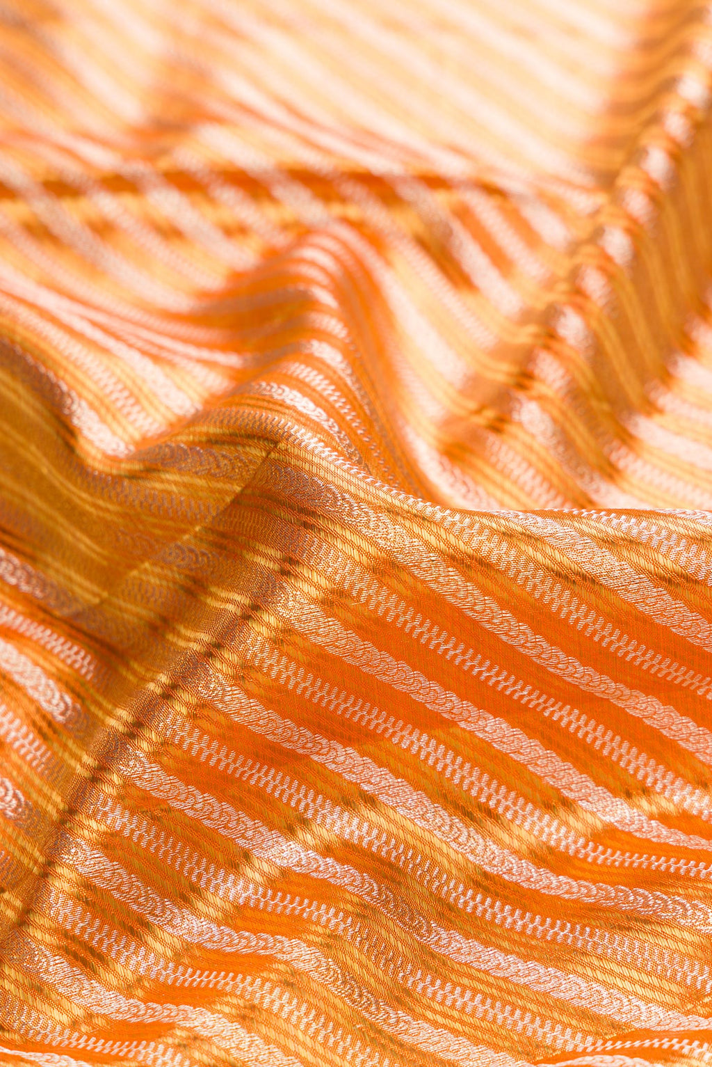 Close up of Orange Dual Tone Kanjivaram Tissue Saree with Zari Brocade on the body and Fancy Border.  displaying folds