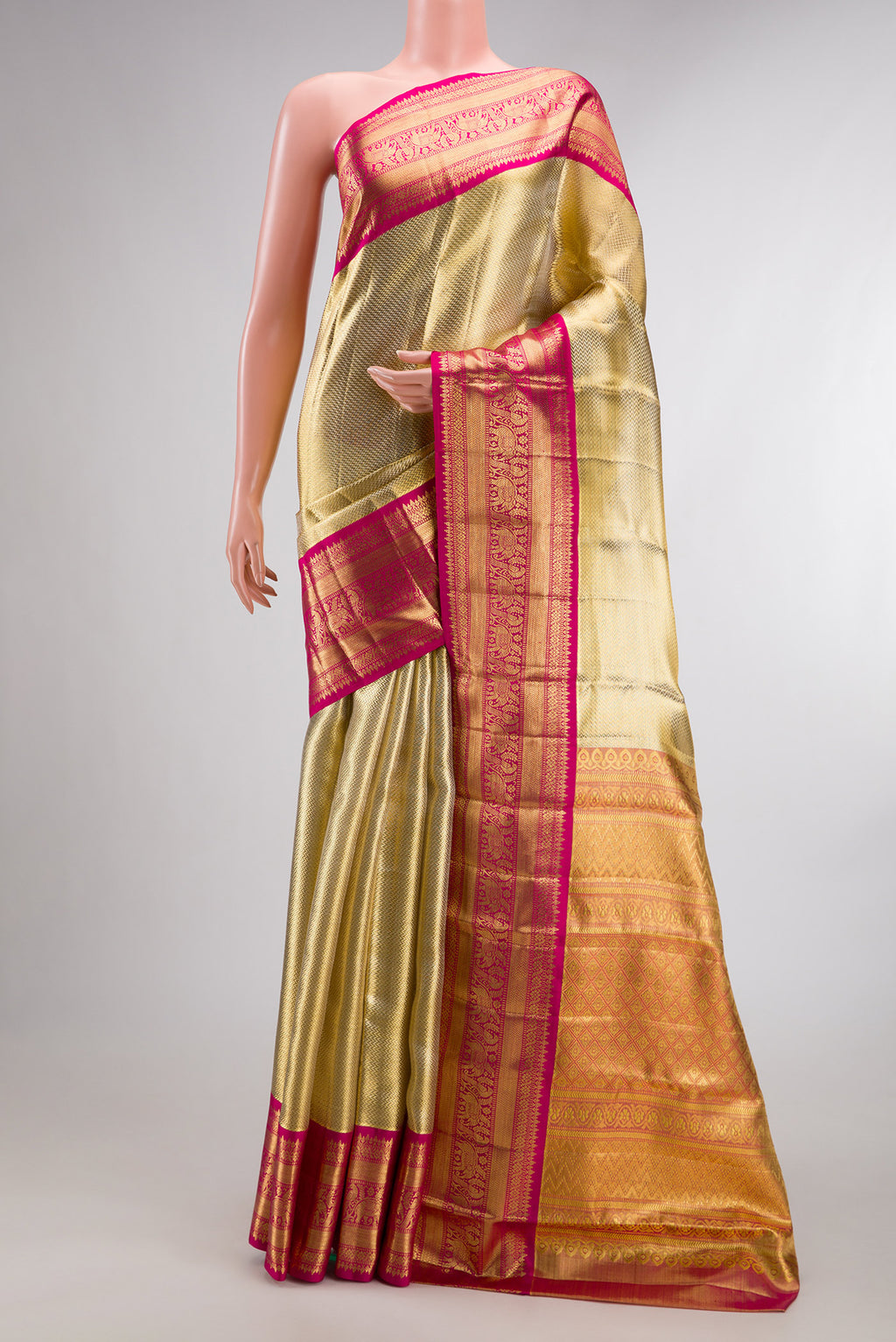 Gold Dual Tone Kanjivaram Tissue Saree with Zari Brocade on the body and Fancy Border.  displayed on a mannequin