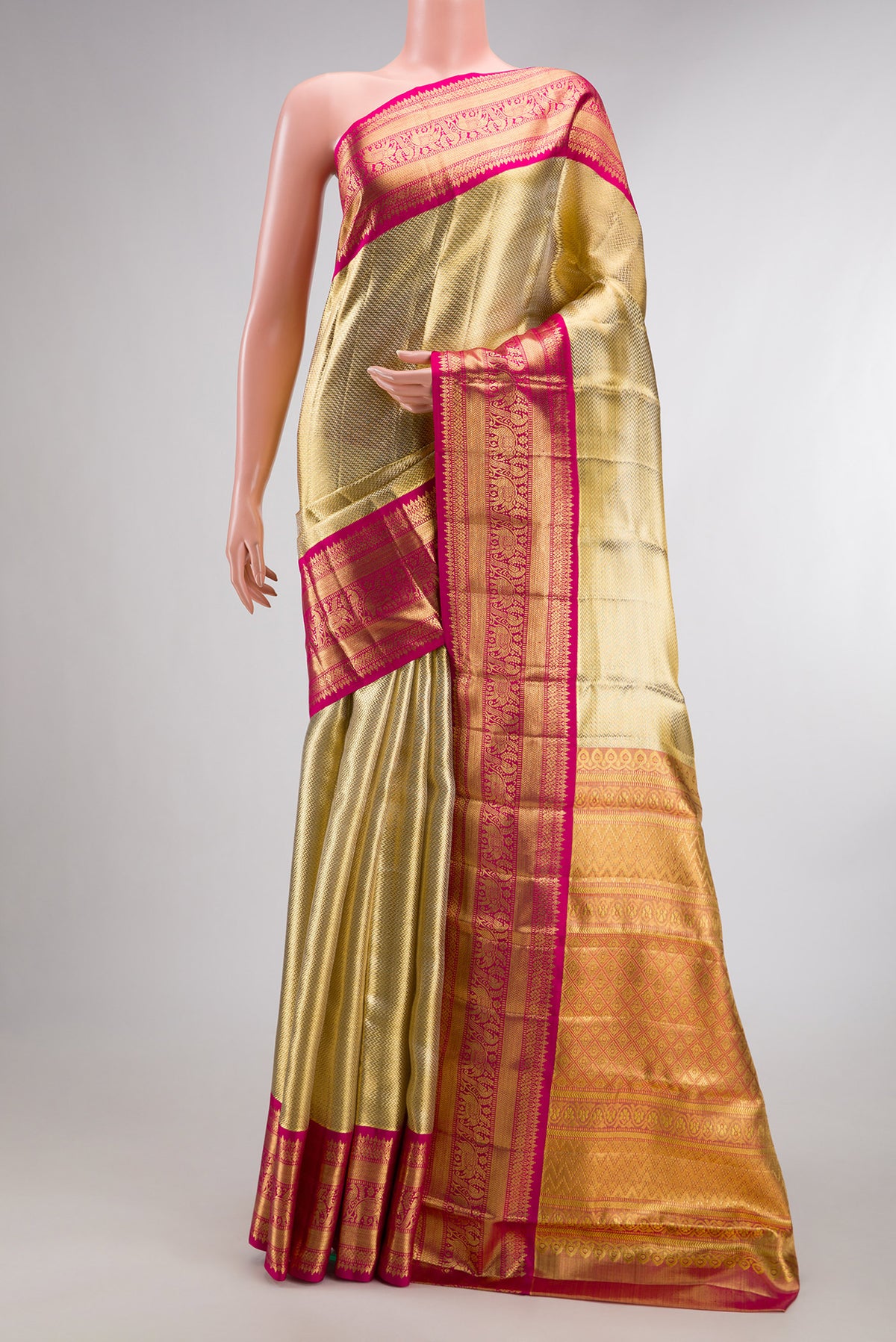 Gold Dual Tone Kanjivaram Tissue Saree with Zari Brocade on the body and Fancy Border.  displayed on a mannequin