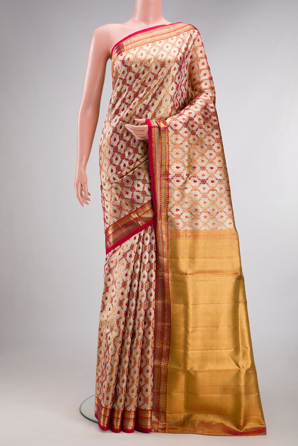 Gold Dual Tone Kanjivaram Tissue Saree with Zari Brocade on the body and Fancy Border.  displayed on a mannequin