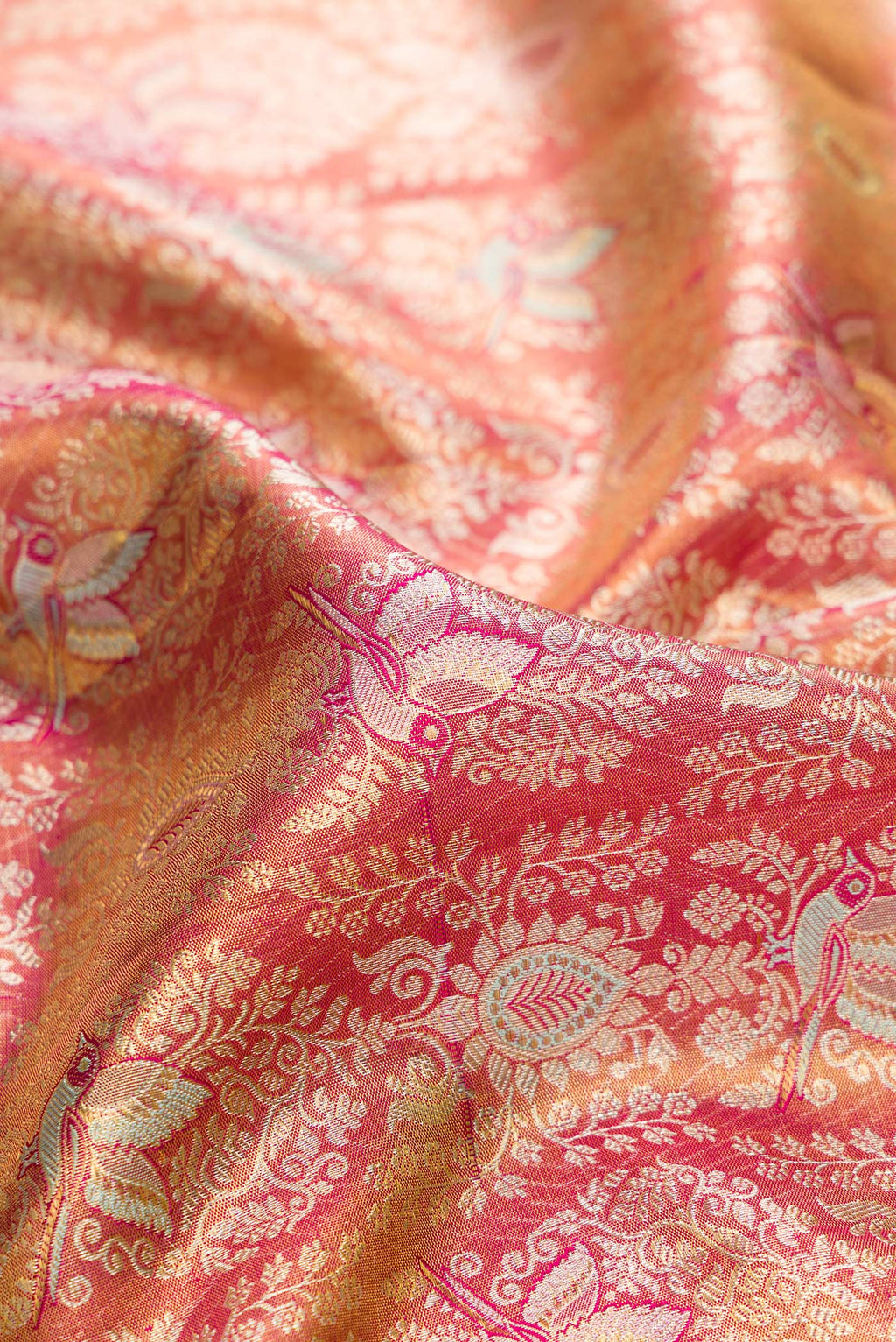 Close up of Gold Dual Tone Kanjivaram Tissue Saree with Zari Brocade on the body and Zari Border.  displaying folds