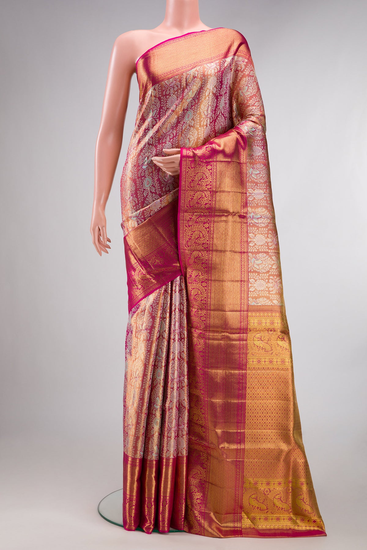 Gold Dual Tone Kanjivaram Tissue Saree with Zari Brocade on the body and Zari Border.  displayed on a mannequin