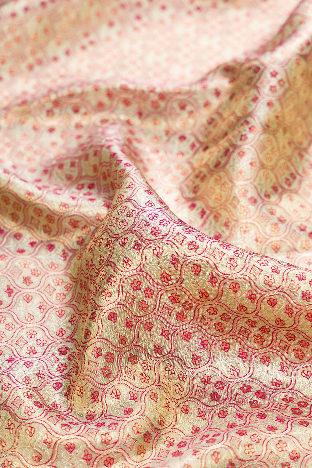 Close up of Gold Dual Tone Kanjivaram Tissue Saree with Zari Brocade on the body and Fancy Border.  displaying folds