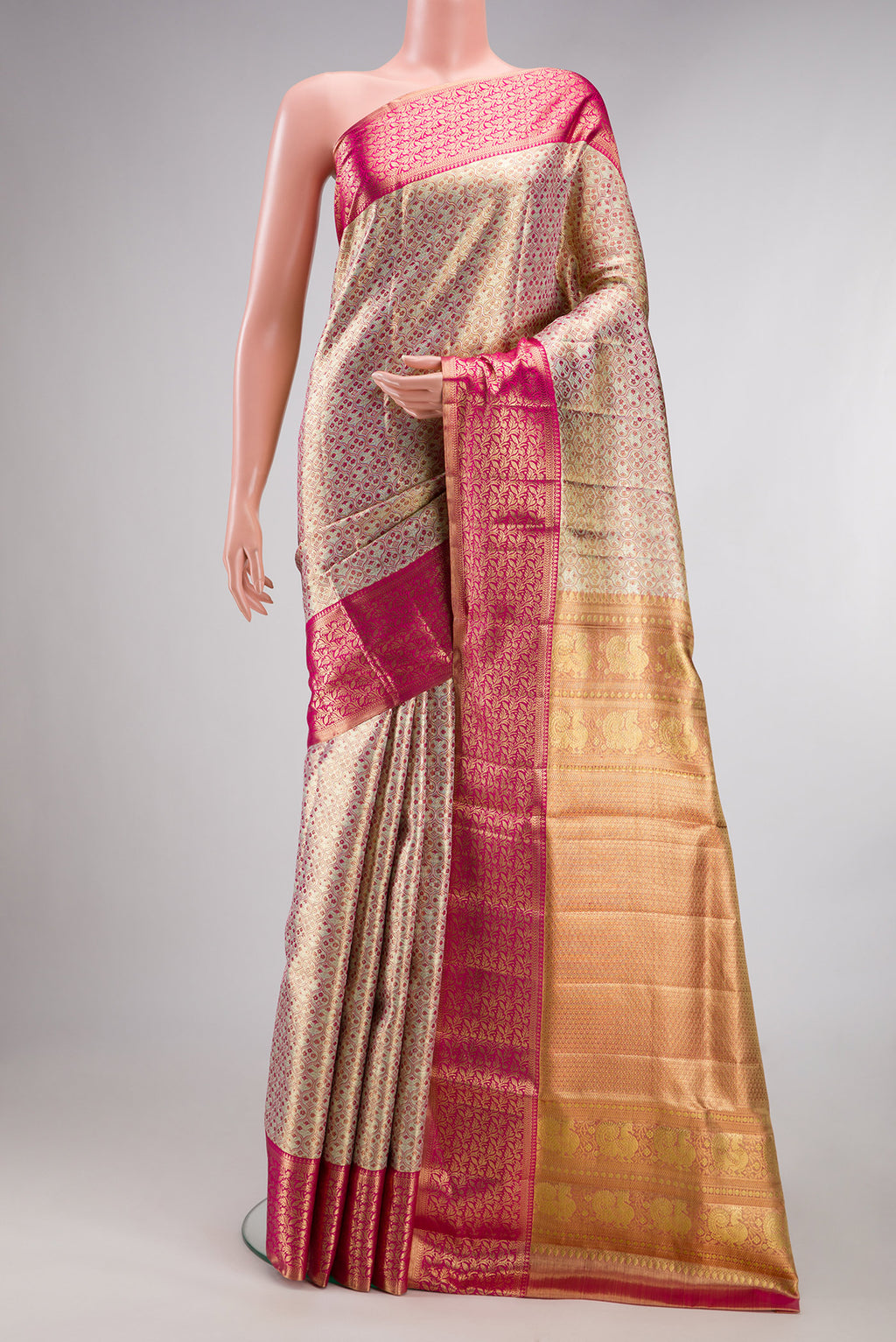 Gold Dual Tone Kanjivaram Tissue Saree with Zari Brocade on the body and Fancy Border.  displayed on a mannequin