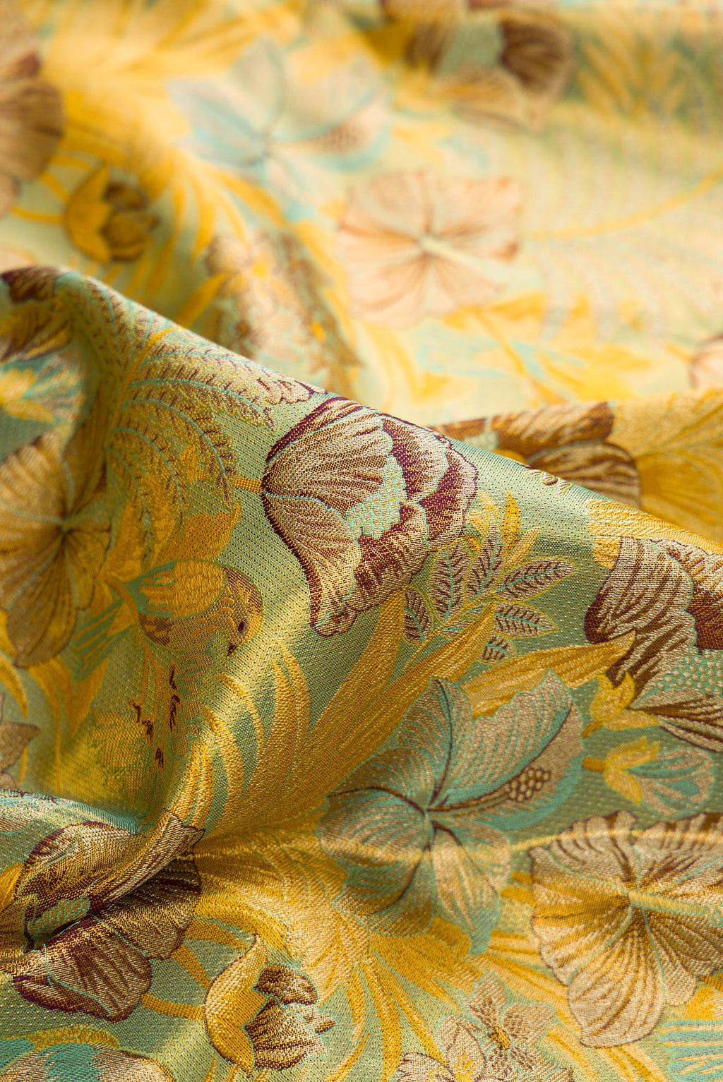 Close up of Sea Green Dual Tone Kanjivaram Tissue Saree with Zari Brocade on the body and Fancy Border.  displaying folds