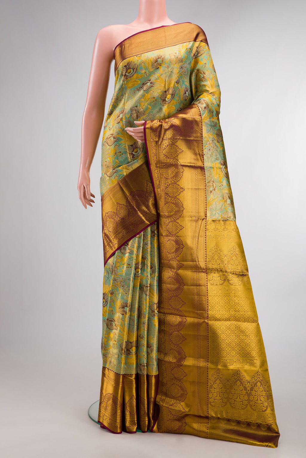 Sea Green Dual Tone Kanjivaram Tissue Saree with Zari Brocade on the body and Fancy Border.  displayed on a mannequin