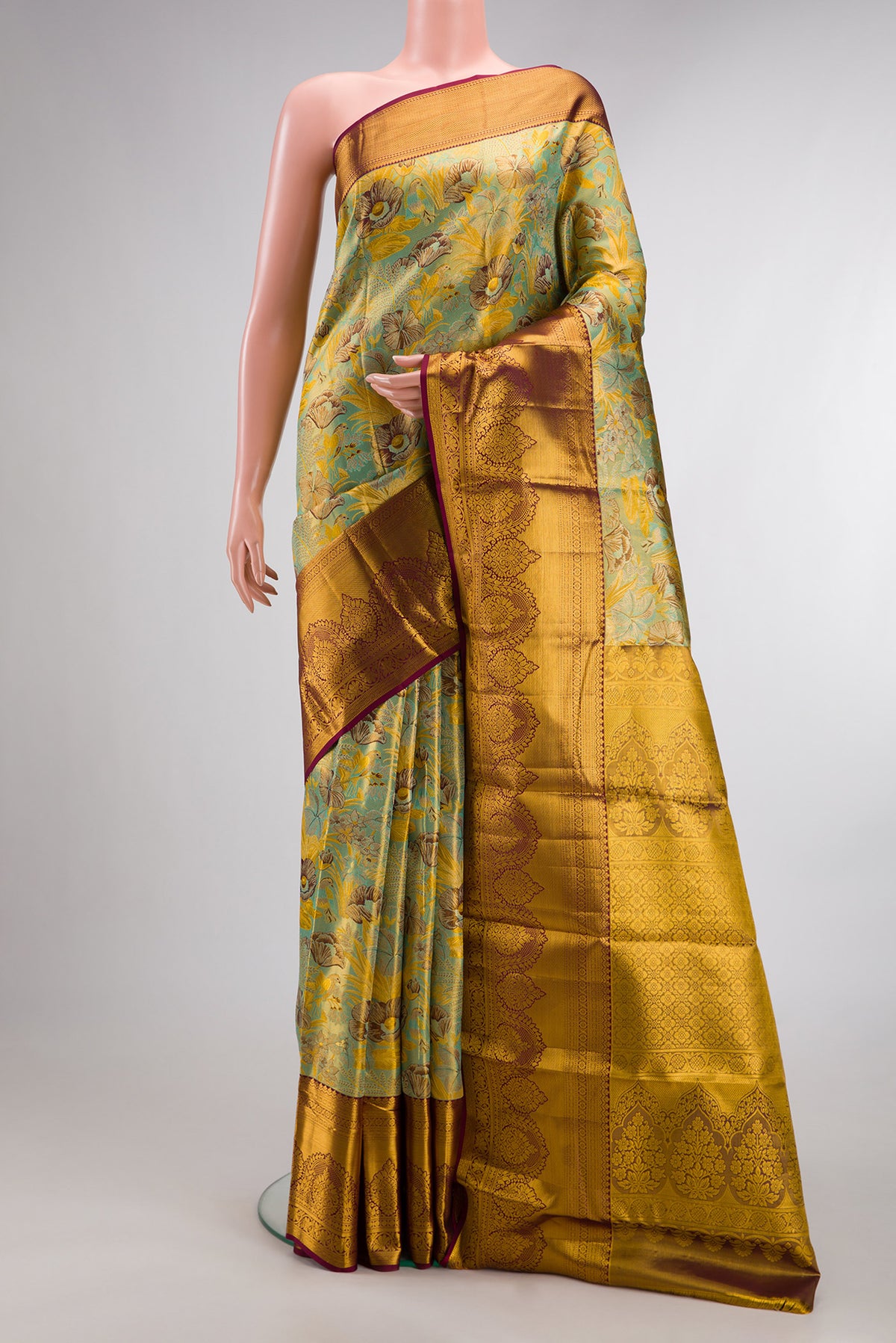 Sea Green Dual Tone Kanjivaram Tissue Saree with Zari Brocade on the body and Fancy Border.  displayed on a mannequin
