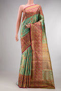 Sea Green Dual Tone Kanjivaram Tissue Saree with Zari Brocade on the body and Fancy Border.  displayed on a mannequin