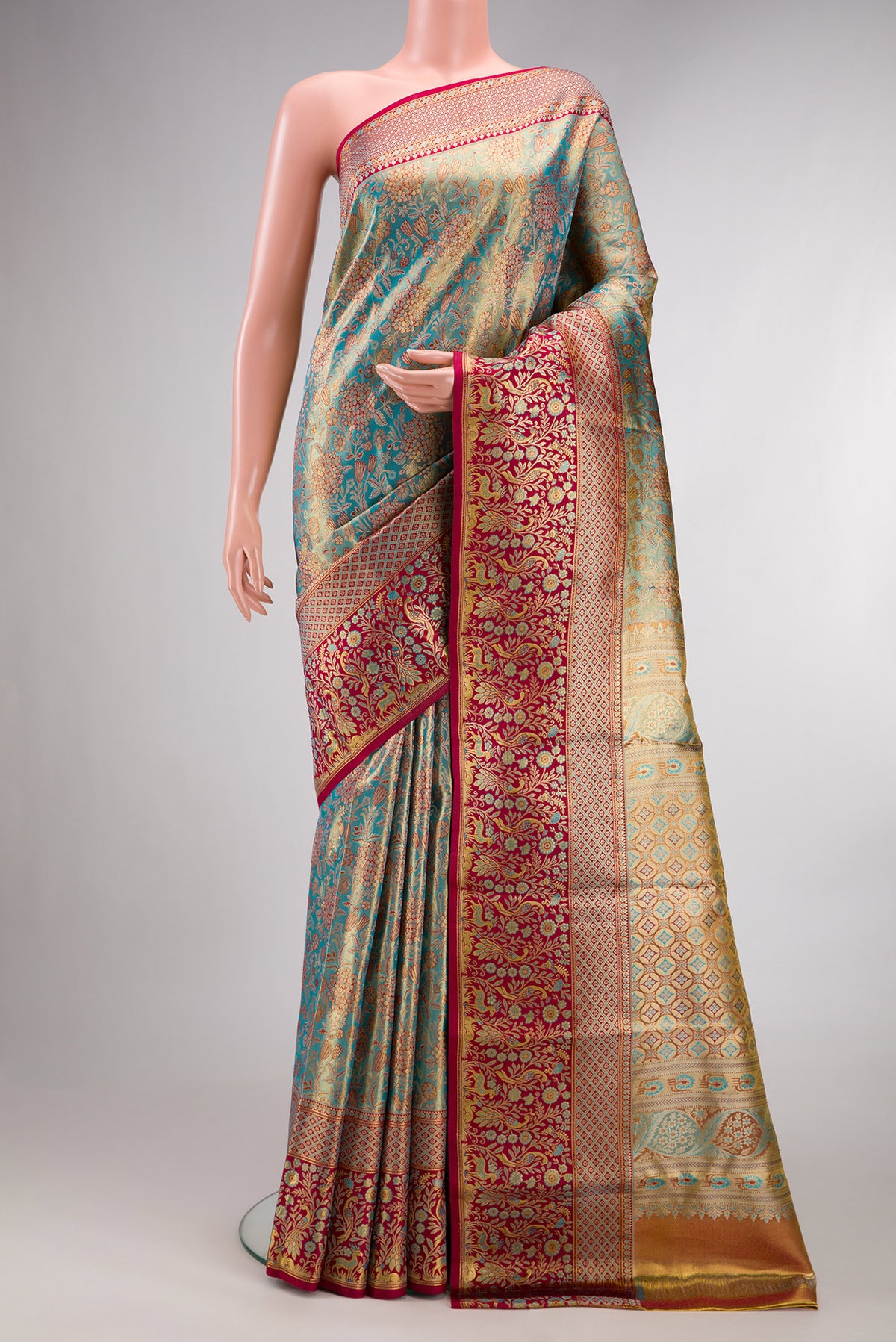 Turquoise Dual Tone Kanjivaram Tissue Saree with Zari Brocade on the body and Fancy Border.  displayed on a mannequin