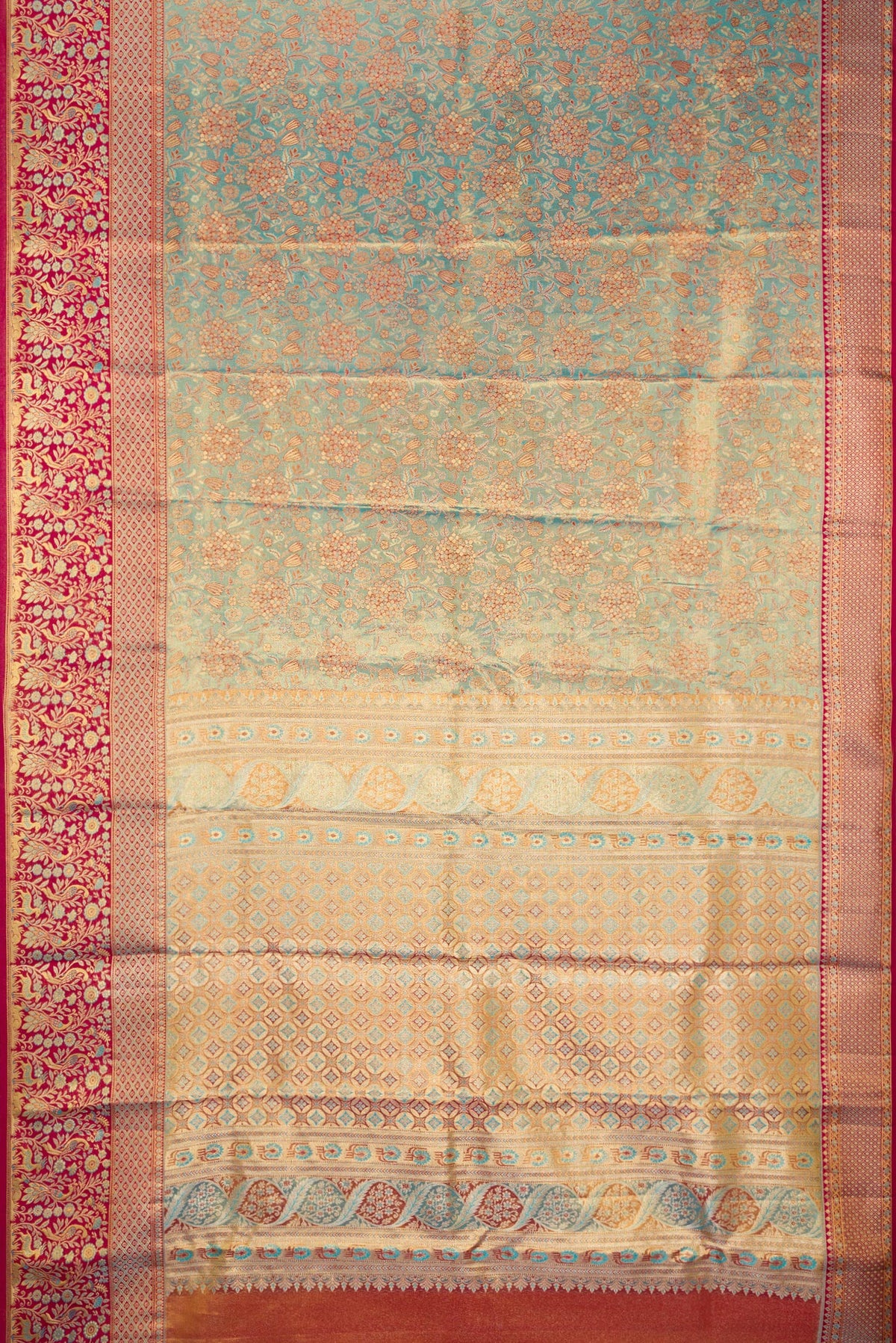Flat view of Turquoise Dual Tone Kanjivaram Tissue Saree with Zari Brocade on the body and Fancy Border. 