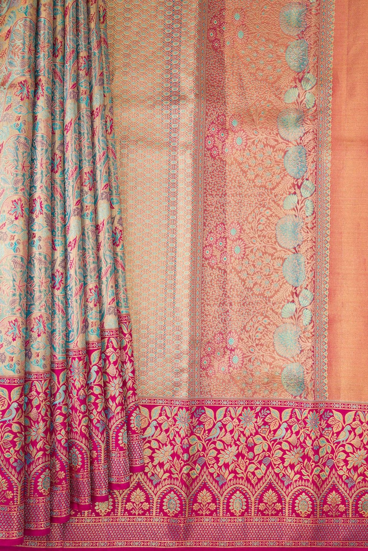 Pleats and pallu of Turquoise Dual Tone Kanjivaram Tissue Saree with Zari Brocade on the body and Fancy Border. 