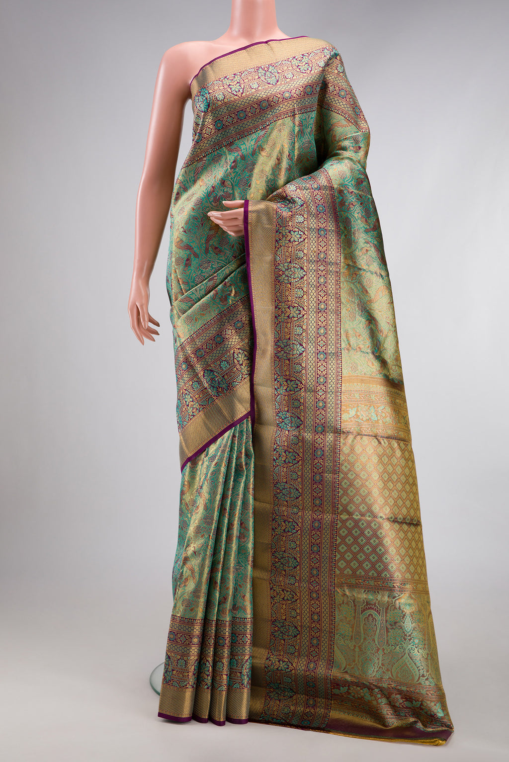 Sea Green Dual Tone Kanjivaram Tissue Silk Saree with Zari Brocade on the body and Fancy Border.  displayed on a mannequin
