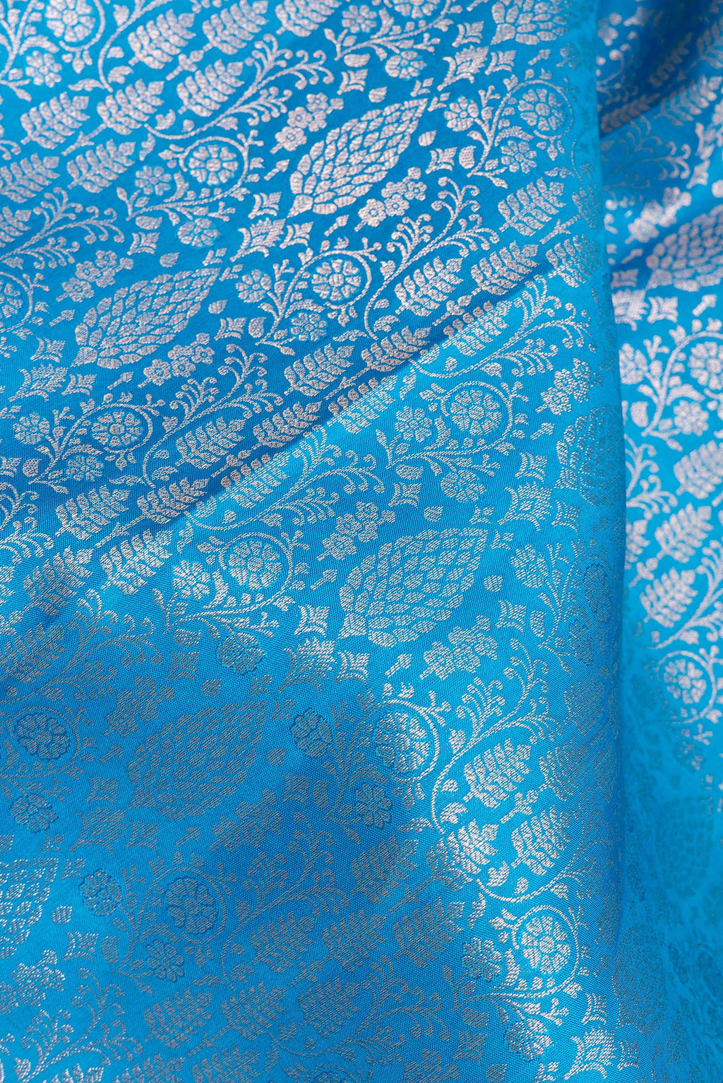 Close up of Pure Silk Sky Blue Kanjivaram Saree with Zari Brocade on the body and Zari Border.  displaying folds