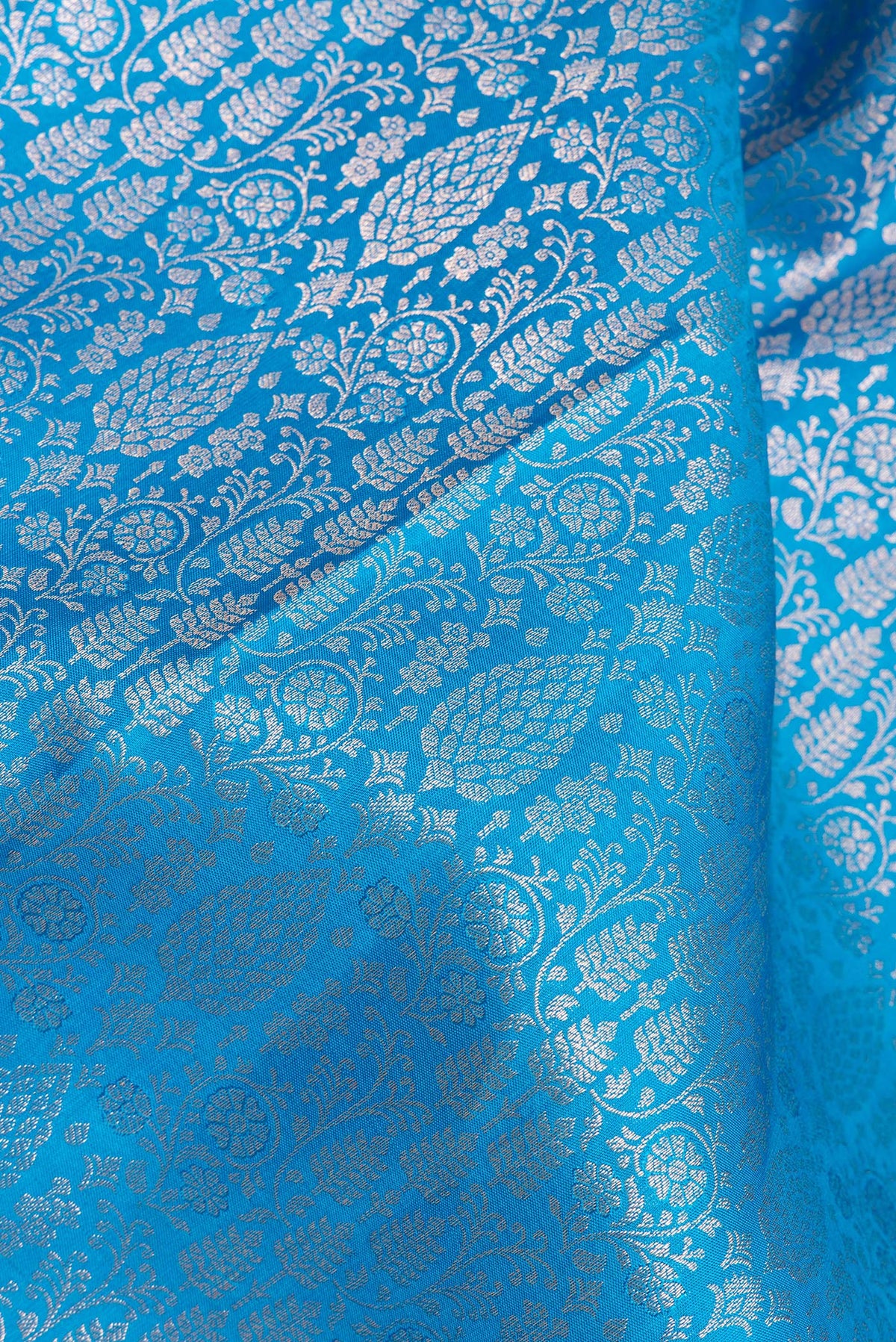 Close up of Pure Silk Sky Blue Kanjivaram Saree with Zari Brocade on the body and Zari Border.  displaying folds