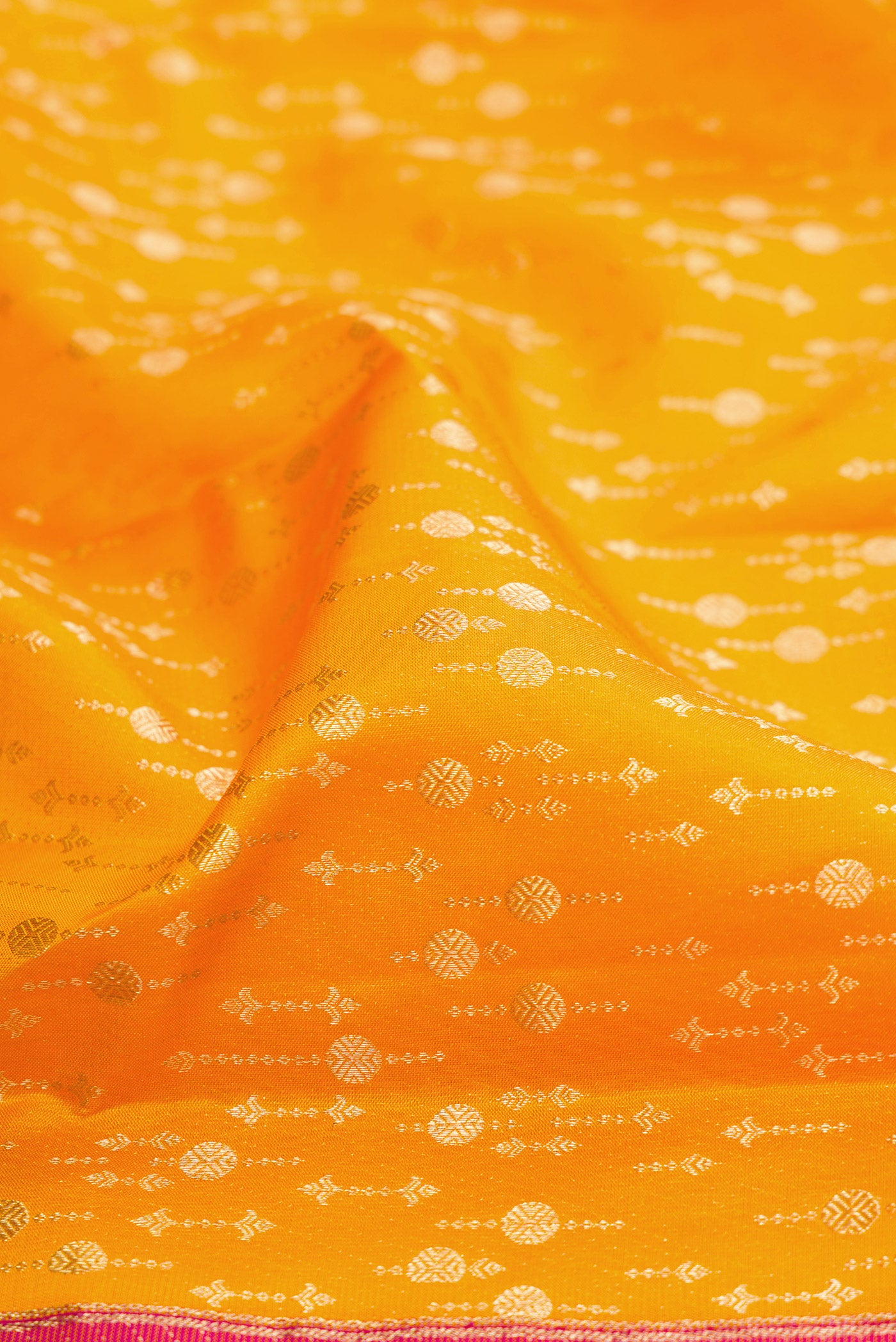 Close up of Mustard Kanchipuram Silk Saree with Zari Brocade on the body and Fancy Border.  displaying folds