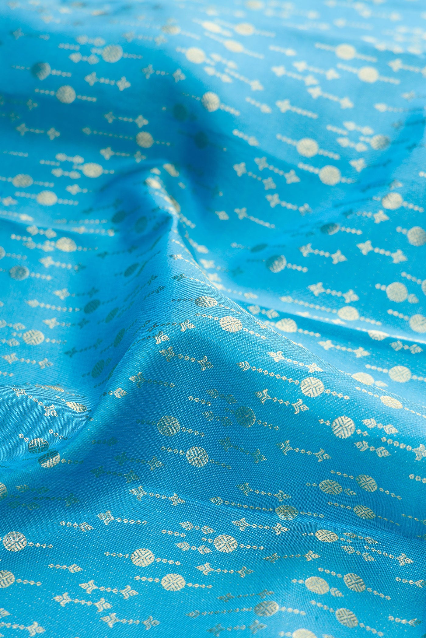 Close up of Sky Blue Kanchipuram Silk Saree with Zari Brocade on the body and Zari Border.  displaying folds