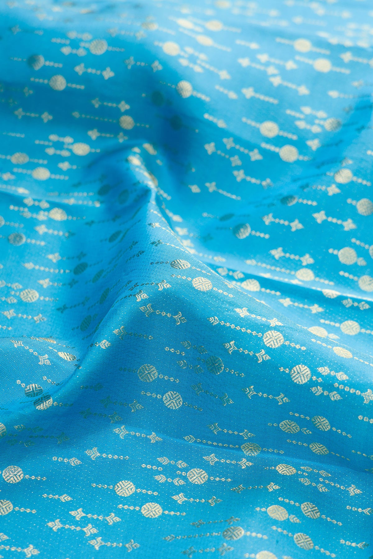 Close up of Sky Blue Kanchipuram Silk Saree with Zari Brocade on the body and Zari Border.  displaying folds