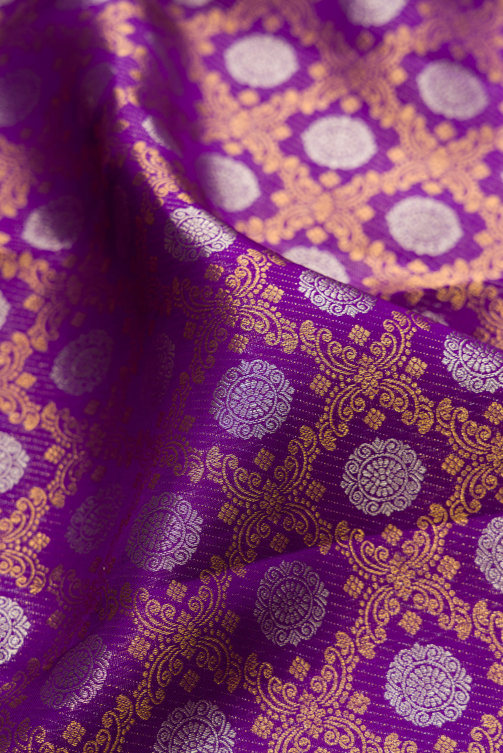 Close up of Pure Silk Purple Kanjivaram Saree with Zari Brocade on the body and Zari Border.  displaying folds