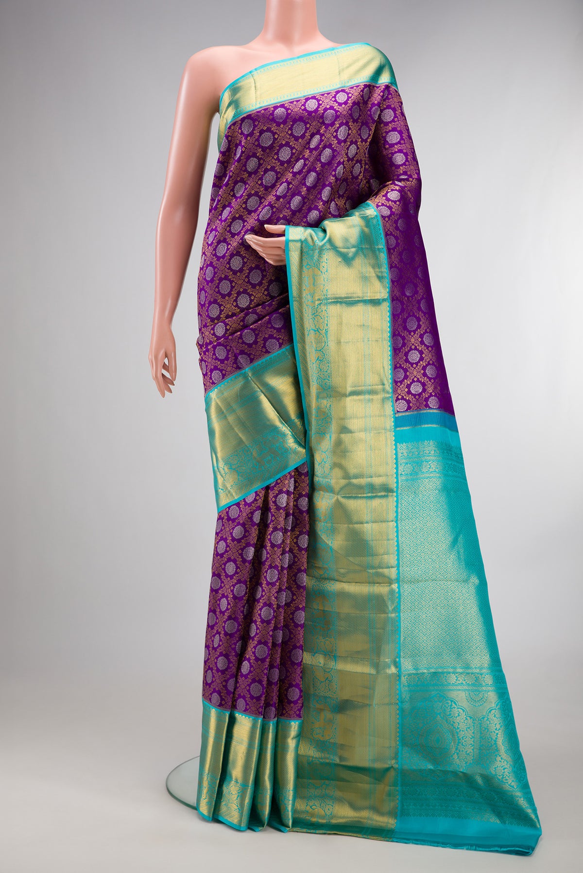 Pure Silk Purple Kanjivaram Saree with Zari Brocade on the body and Zari Border.  displayed on a mannequin