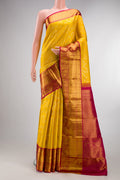 Pure Silk Yellow Kanjivaram Saree with Zari Brocade on the body and Zari Border.  displayed on a mannequin