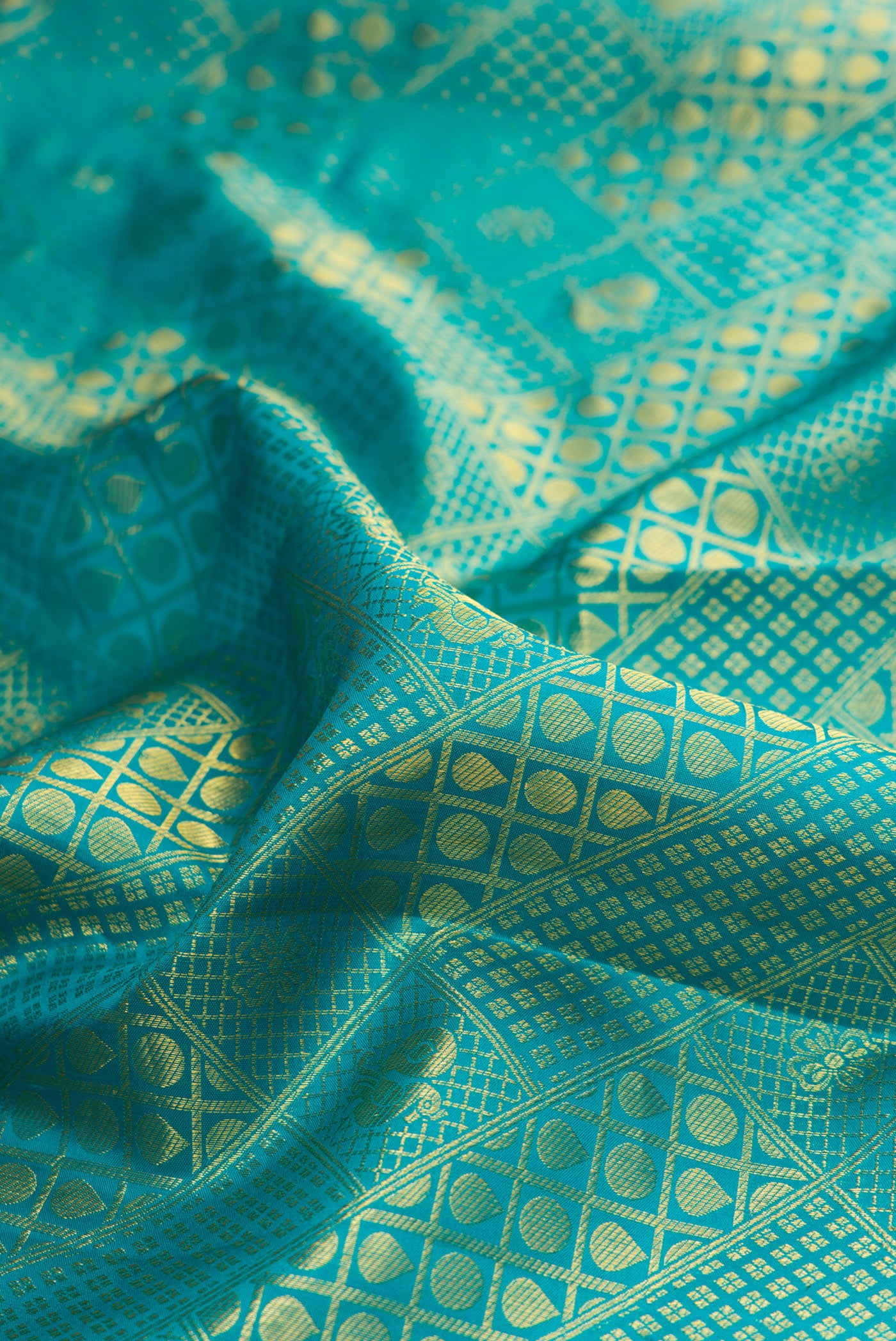 Close up of Sea Green Kanjivaram Silk Saree with Zari Brocade on the body and Fancy Border.  displaying folds