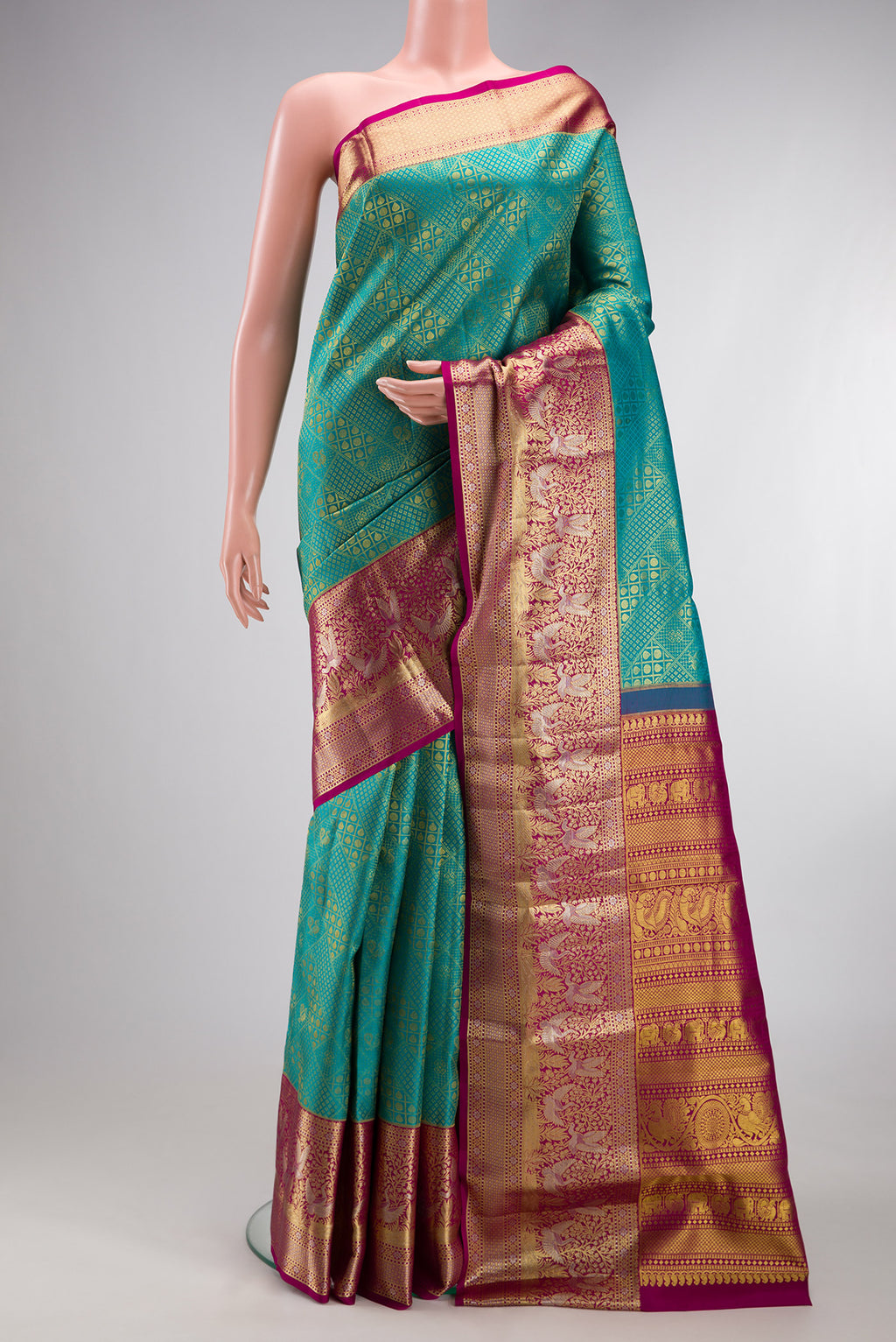 Sea Green Kanjivaram Silk Saree with Zari Brocade on the body and Fancy Border.  displayed on a mannequin