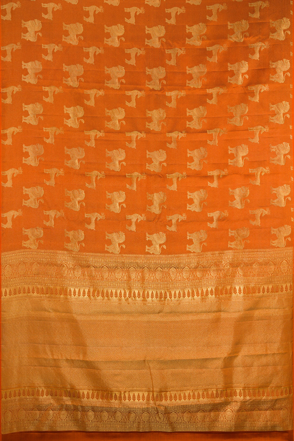 Flat view of Rust Kanchipuram Silk Saree with Zari Brocade on the body and Without Border. 