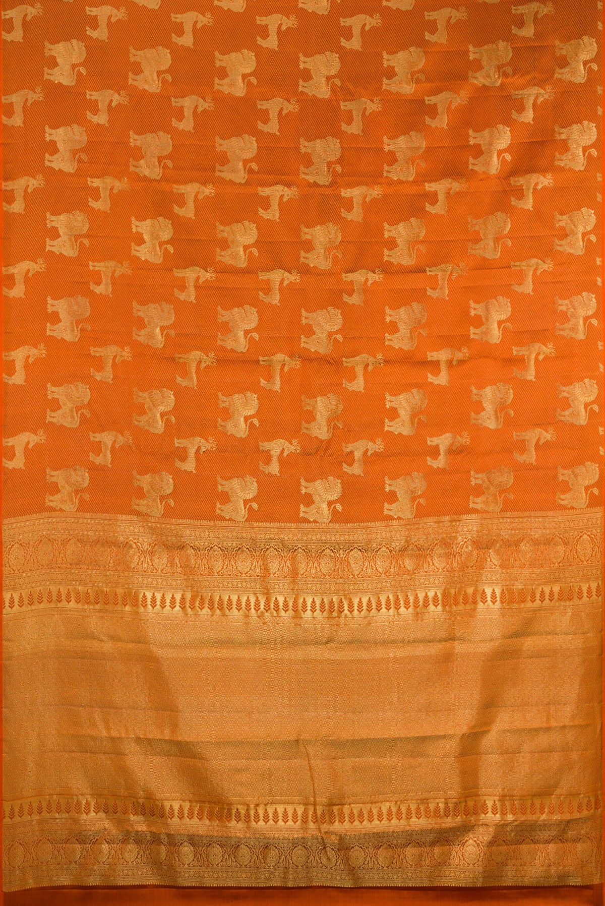 Flat view of Rust Kanchipuram Silk Saree with Zari Brocade on the body and Without Border. 