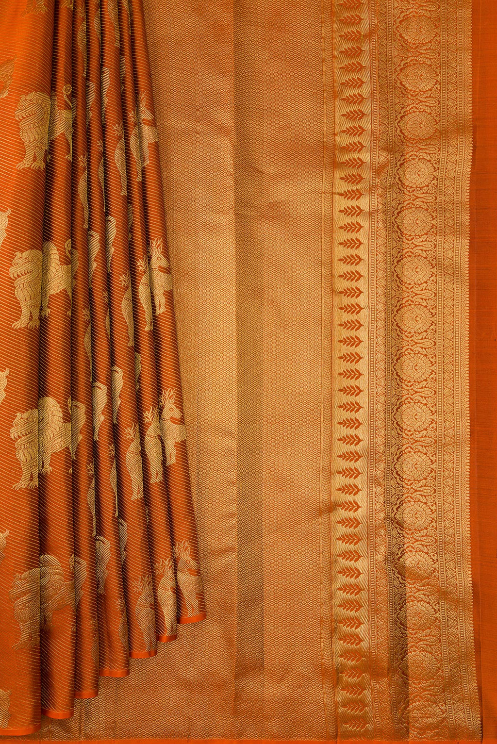Pleats and pallu of Rust Kanchipuram Silk Saree with Zari Brocade on the body and Without Border. 