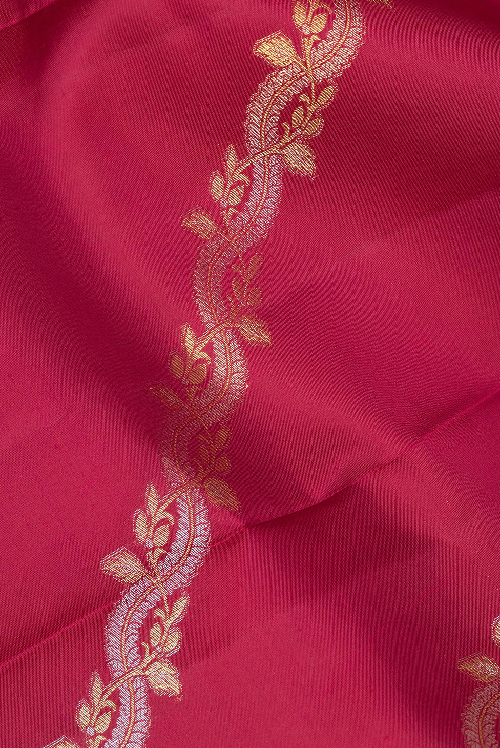 Close up of Pure Silk Maroon Kanchipuram Saree with Zari Butta on the body and Fancy Border.  displaying folds