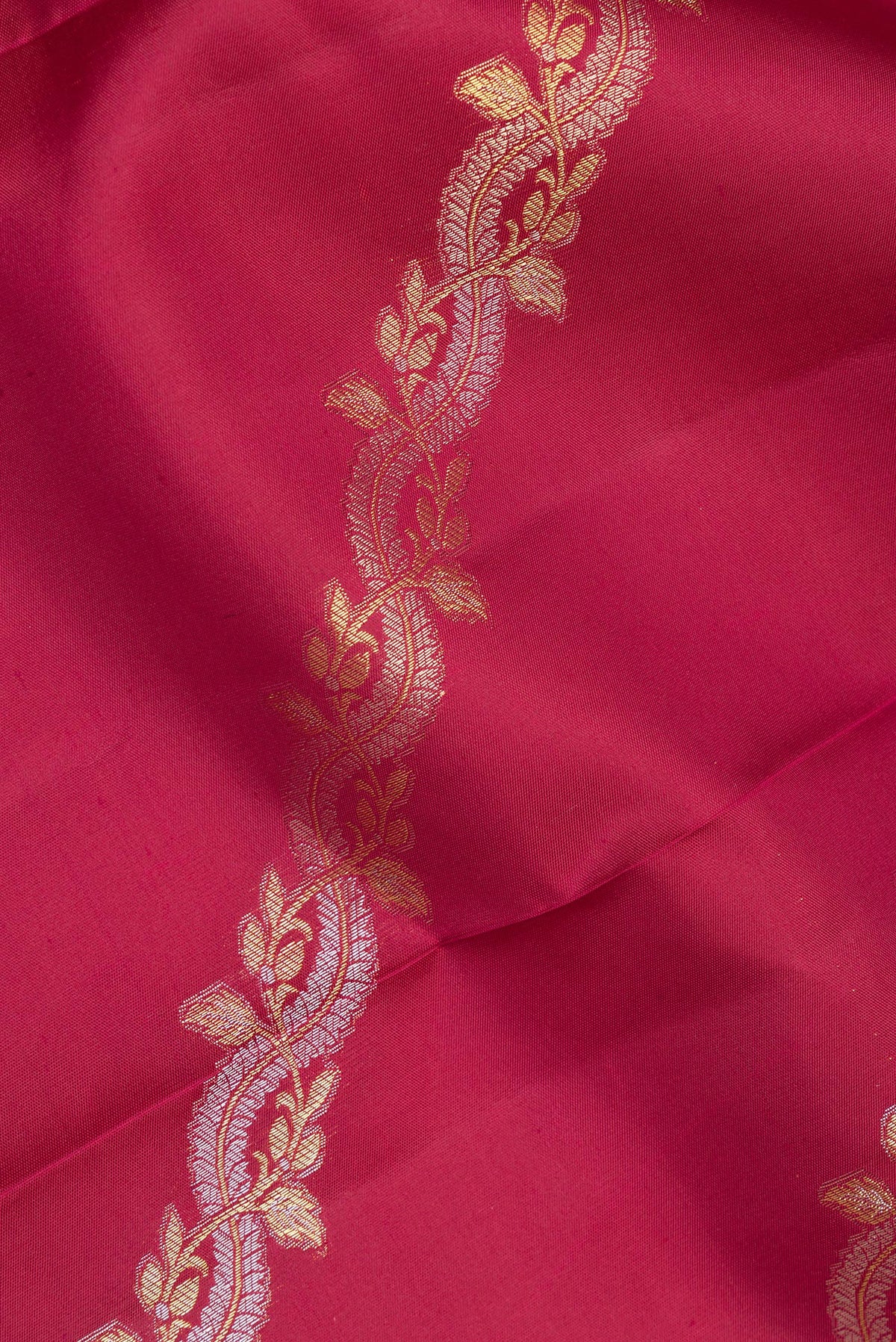 Close up of Pure Silk Maroon Kanchipuram Saree with Zari Butta on the body and Fancy Border.  displaying folds