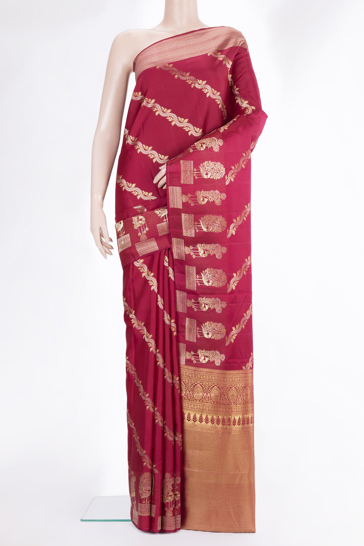 Pure Silk Maroon Kanchipuram Saree with Zari Butta on the body and Fancy Border.  displayed on a mannequin