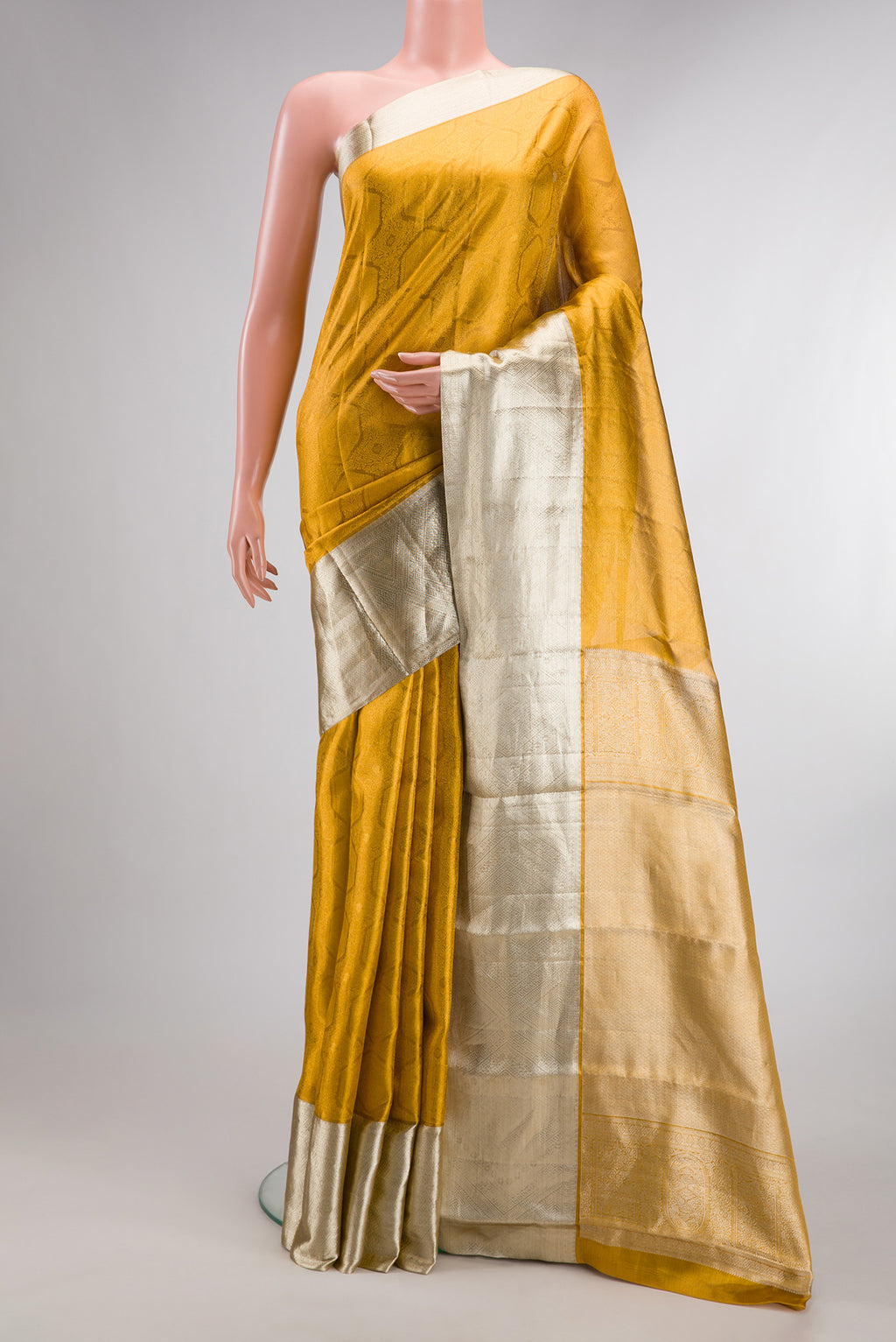 Sandal Dual Tone Kanjivaram Tissue Saree with Zari Brocade on the body and Zari Border.  displayed on a mannequin
