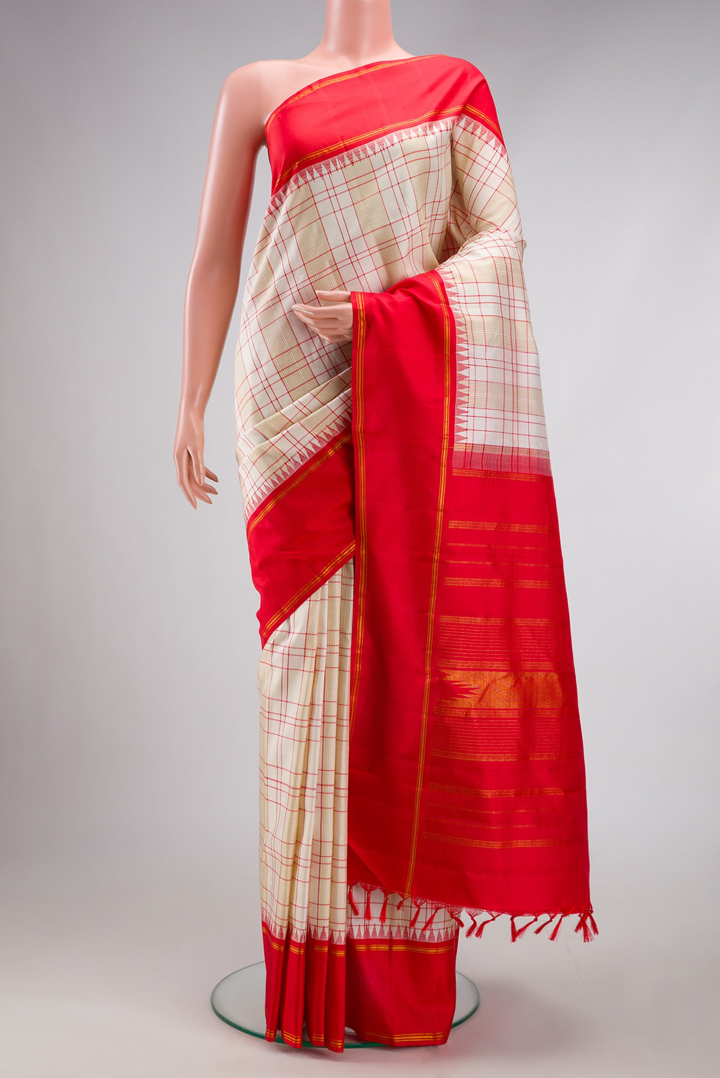 Cream Kanjivaram Silk Saree with Checked design on the body and Zari Border.  displayed on a mannequin