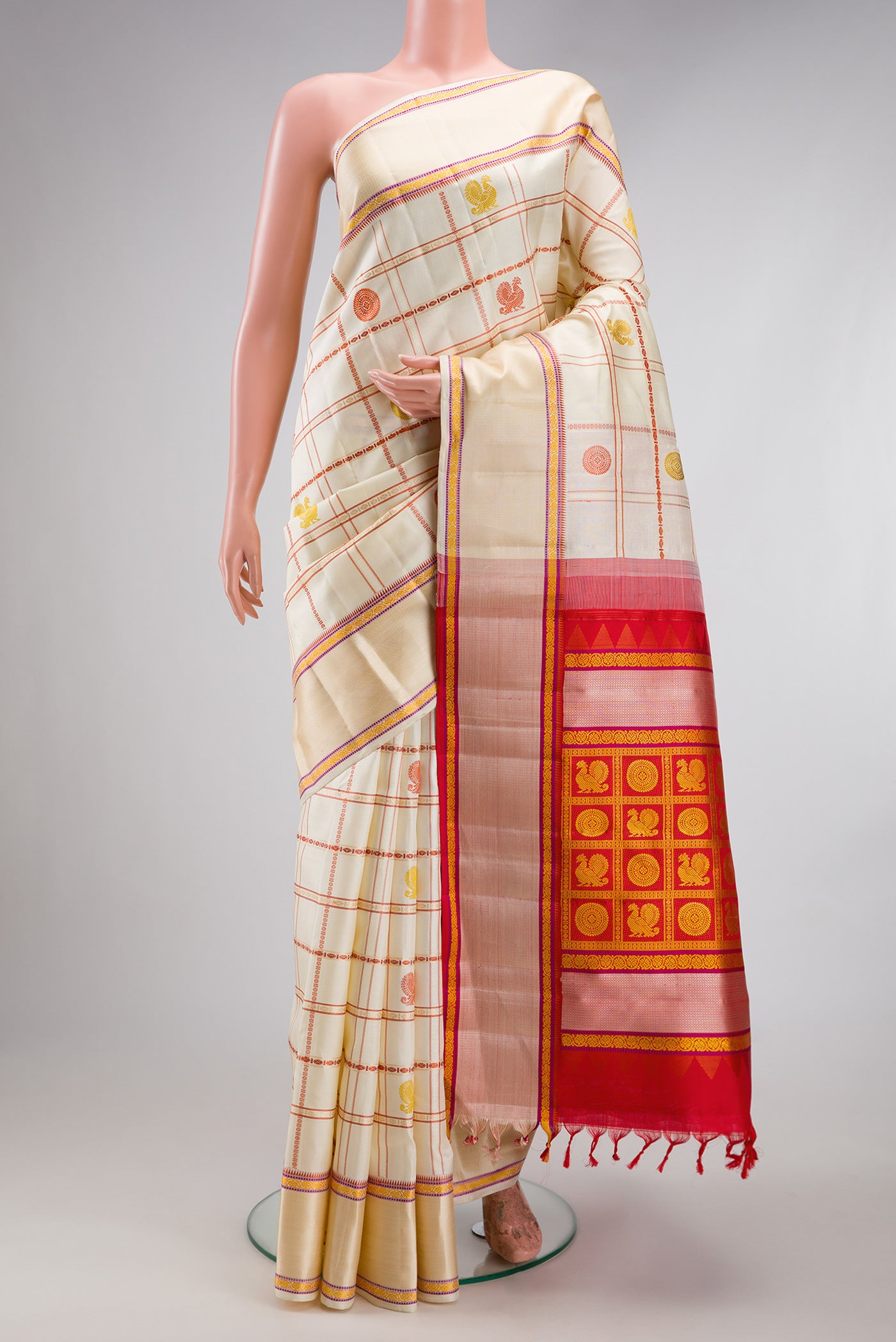 Cream Kanchipuram Silk Saree with Checked design on the body and Thread Border.  displayed on a mannequin