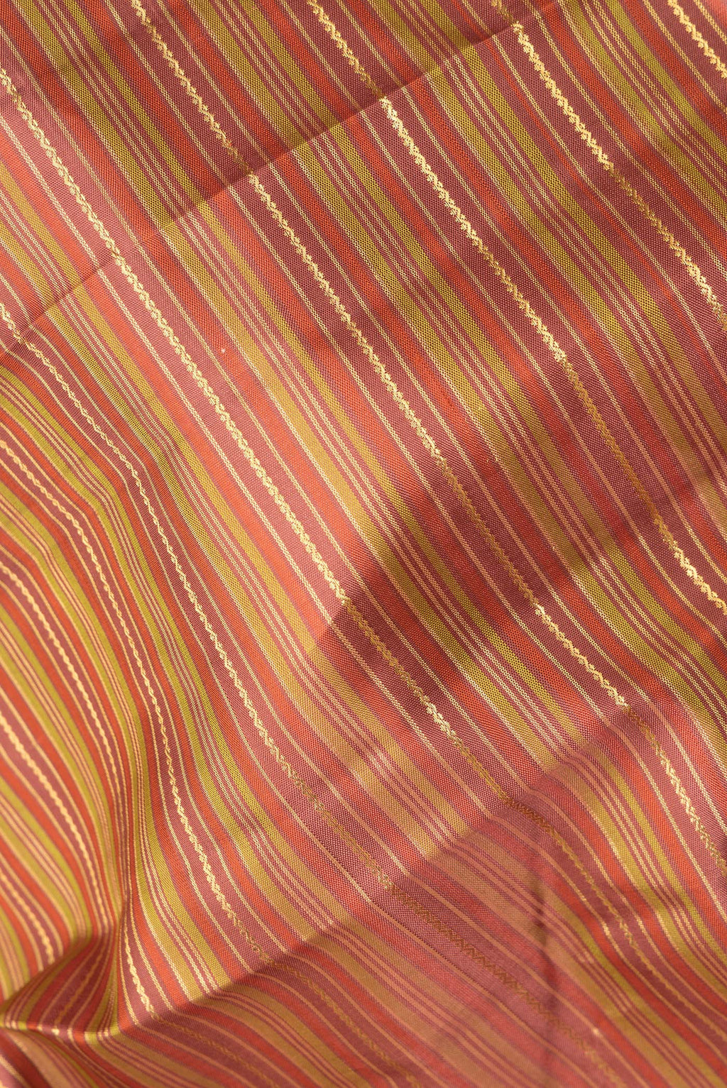 Close up of Pure Silk Rust and Green Color Kanchipuram Saree with Stripes on the body and Zari Border.  displaying folds