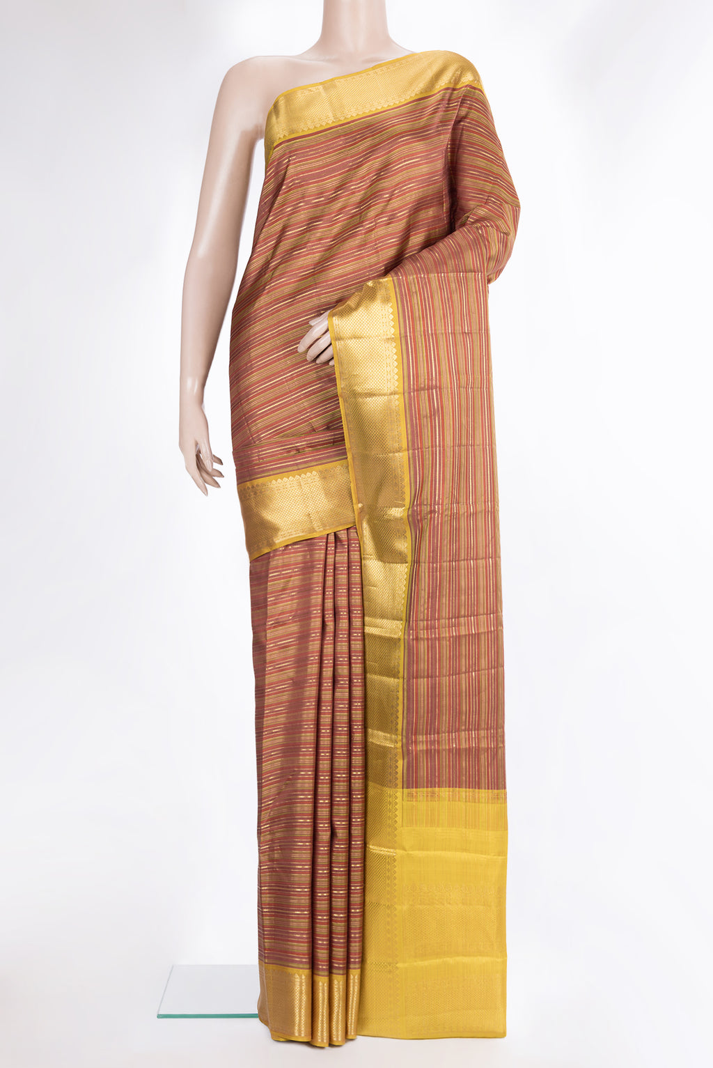 Pure Silk Rust and Green Color Kanchipuram Saree with Stripes on the body and Zari Border.  displayed on a mannequin