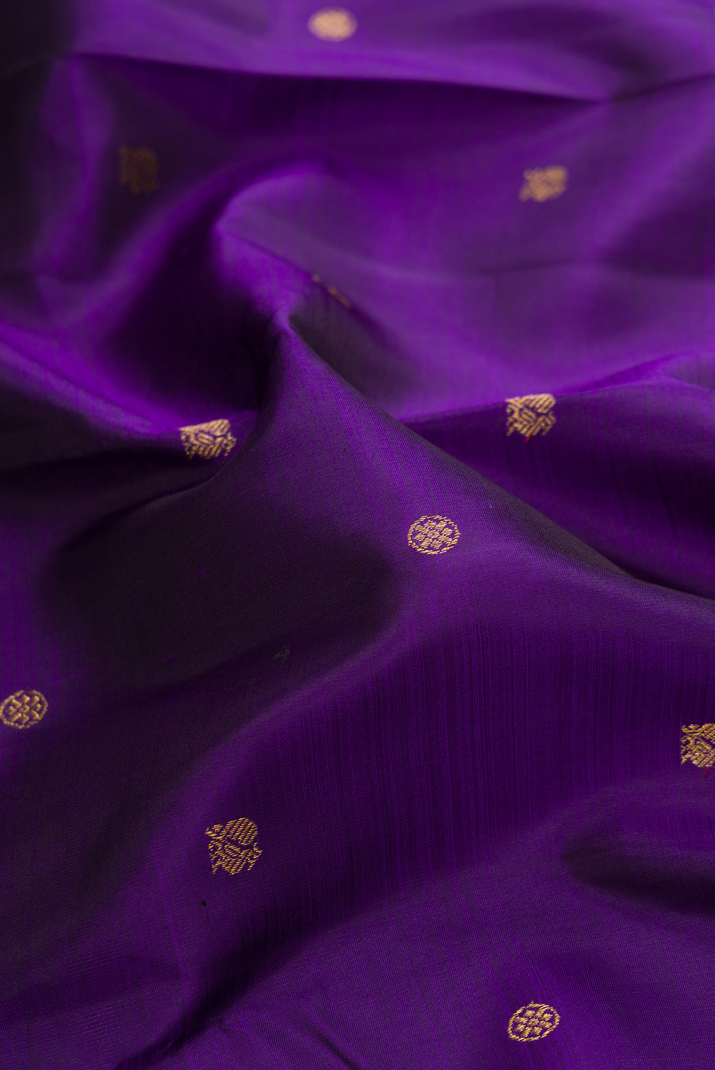 Close up of Pure Silk Violet Kanjivaram Saree with Zari Butta on the body and Zari Border.  displaying folds