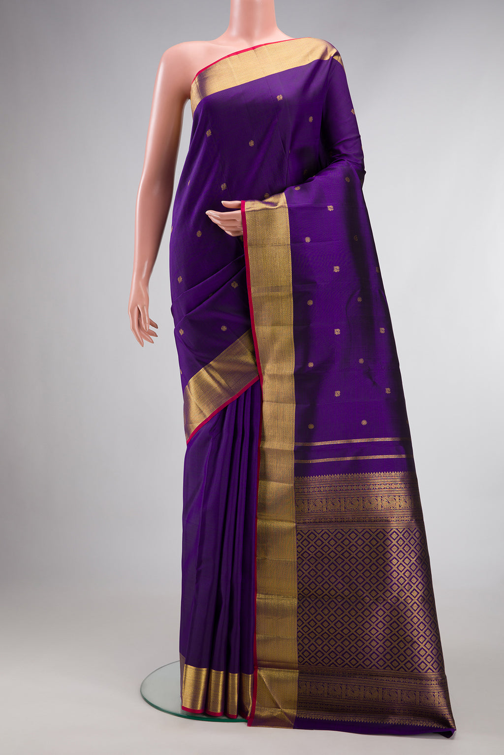 Pure Silk Violet Kanjivaram Saree with Zari Butta on the body and Zari Border.  displayed on a mannequin