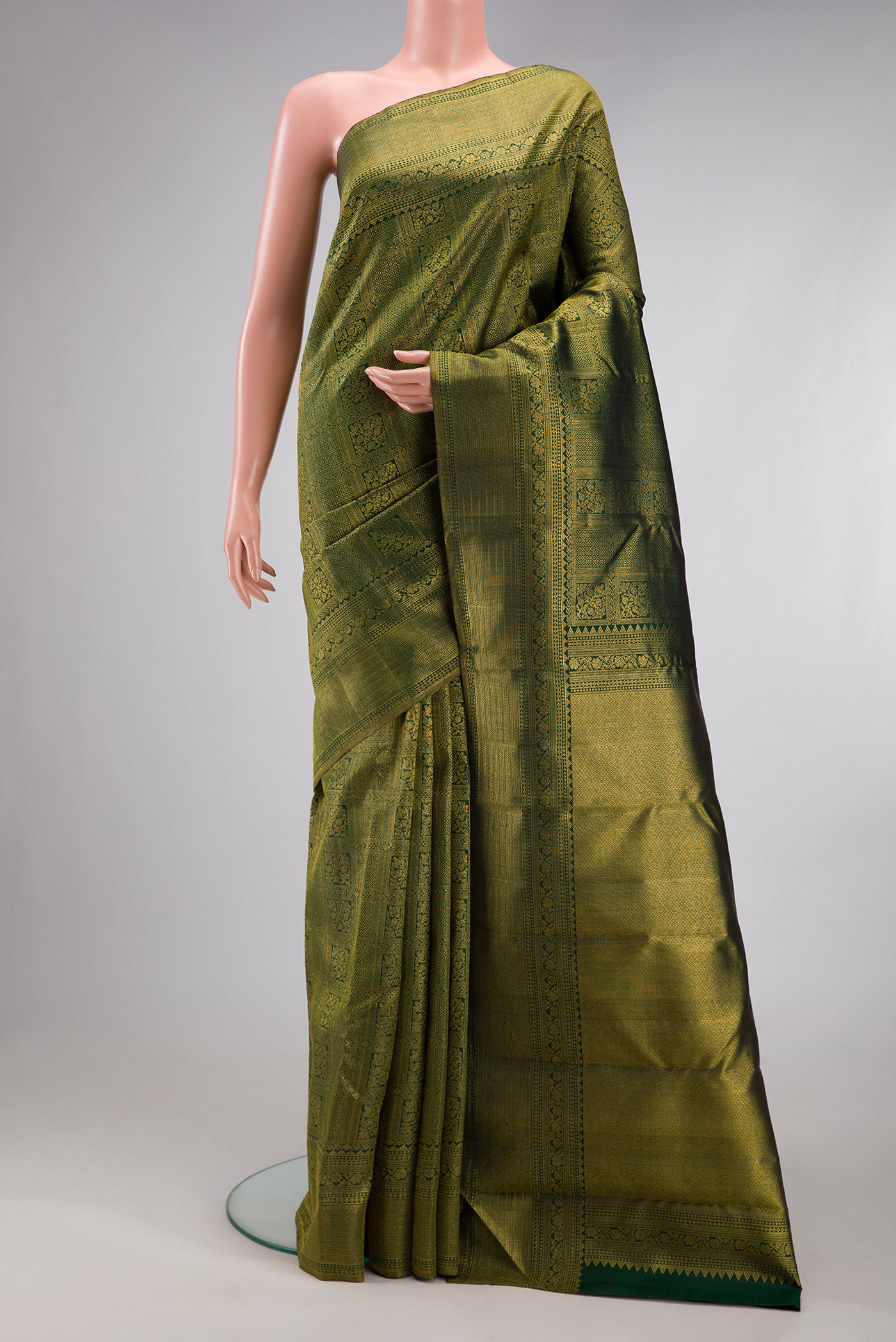 Bottle Green Kanchipuram Silk Saree with Zari Brocade on the body and Fancy Border.  displayed on a mannequin
