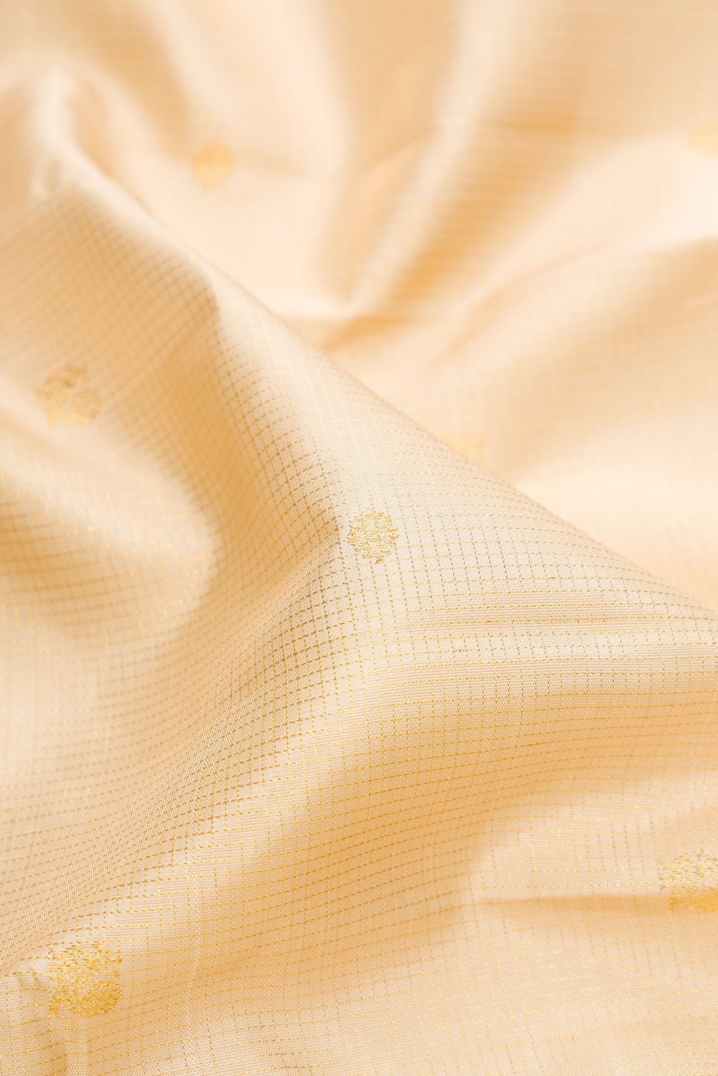 Close up of Sandal Kanchipuram Silk Saree with Checked design on the body and Zari Border.  displaying folds