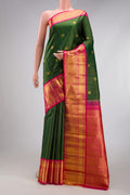Bottle Green Kanchipuram Silk Saree with Checked design on the body and Zari Border.  displayed on a mannequin