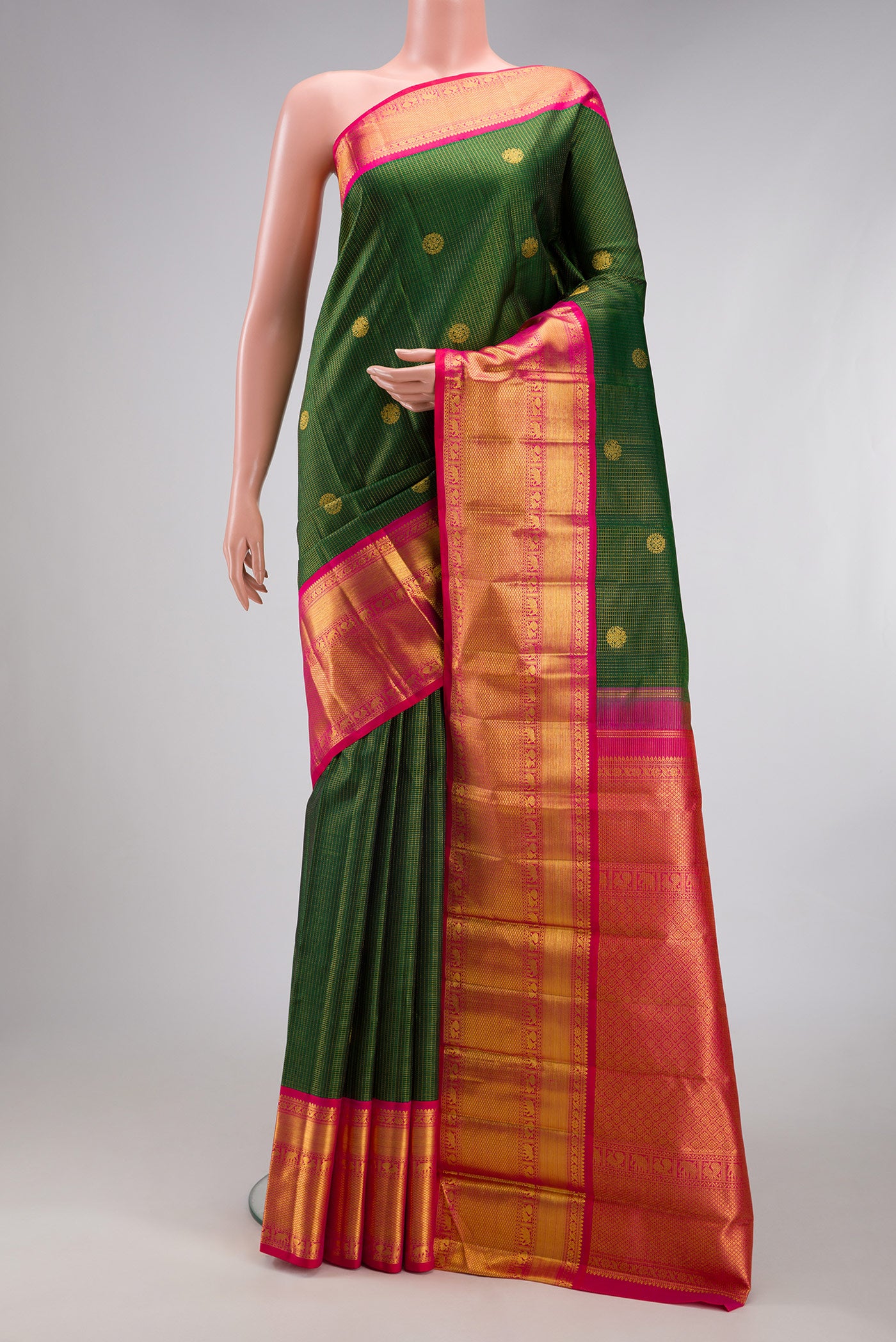 Bottle Green Kanchipuram Silk Saree with Checked design on the body and Zari Border.  displayed on a mannequin